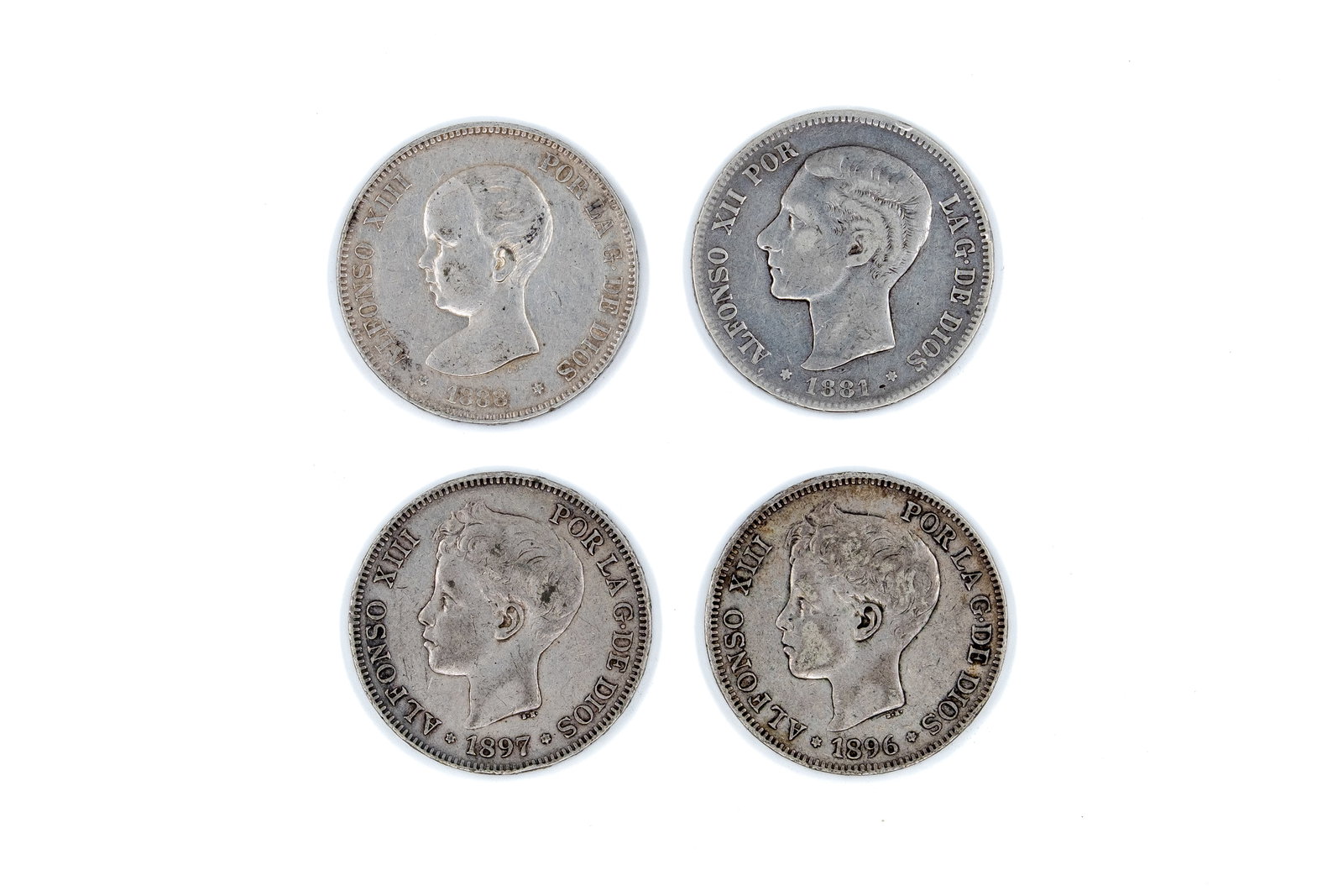 A lot of four Spanish silver 5 Pesetas coins of Alfonso XII and Alfonso XIII: A lot of four Spanish silver 5 Pesetas coins of Alfonso XII and Alfonso XIII, dated 1881-1897. With portraits of the kings on the obverse. Reverse with crowned Spanish coat of arms between Pillars. To