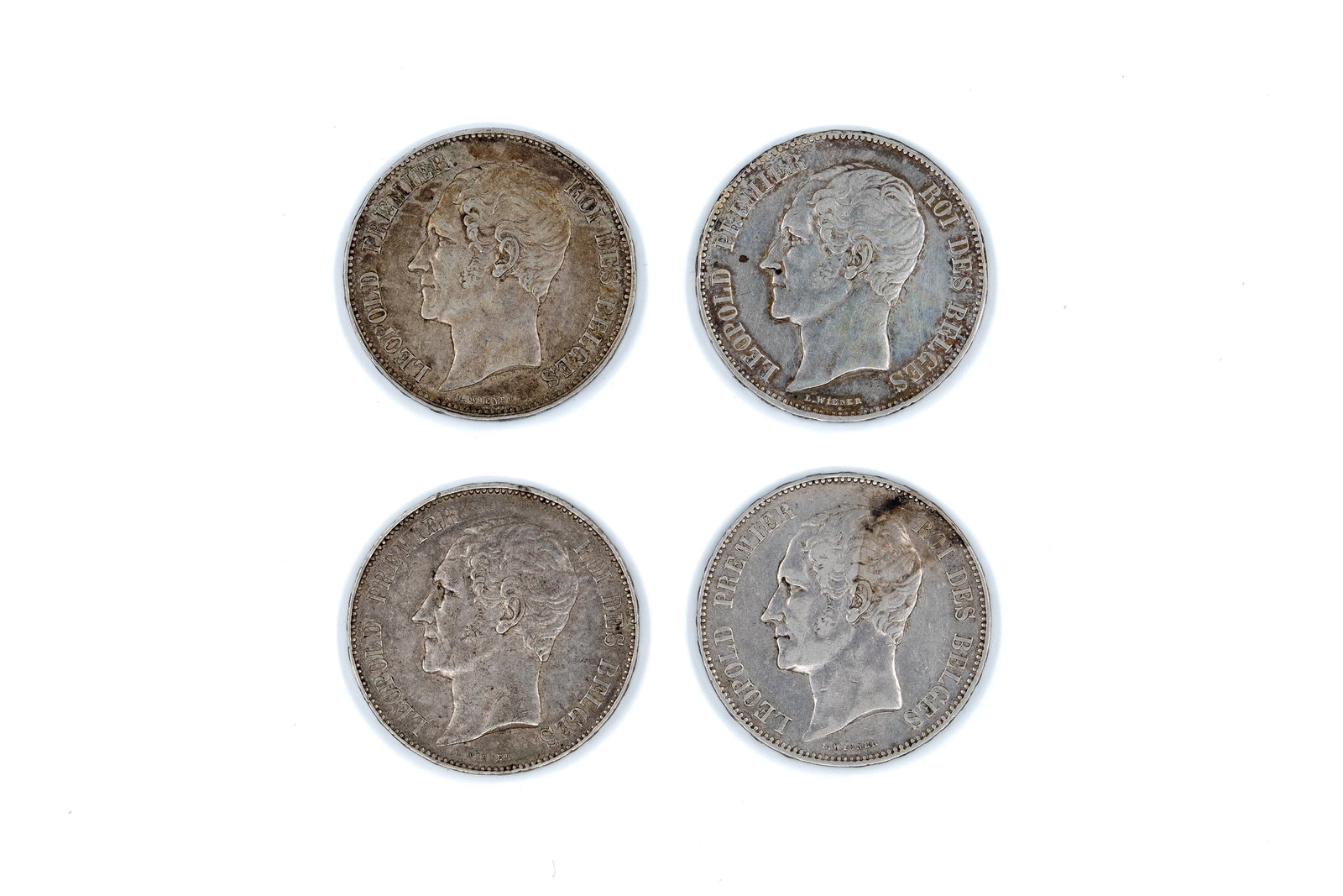 A lot of four Belgian silver 5 Francs coins of Leopold I, dated 1849-1865: A lot of four Belgian silver 5 Francs coins of Leopold I, dated 1849-1865. With portrait of the king on the obverse. Reverse with crowned Belgian coat of arms within wreath and denomination. Total wei