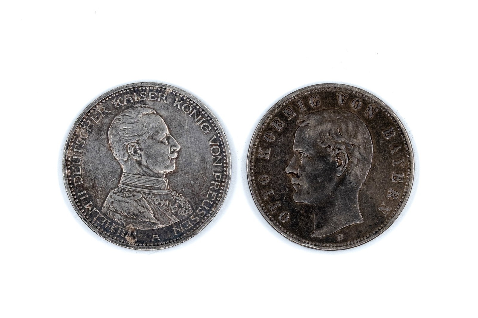 A lot of two German silver 5 Mark coins of the German Empire, dated 1907-1913: A lot of two German silver 5 Mark coins of the German Empire, dated 1907-1913. Comprising issues of Prussia and Bavaria, with obverses depicting Wilhelm II and Otto, and the reverse featuring the impe