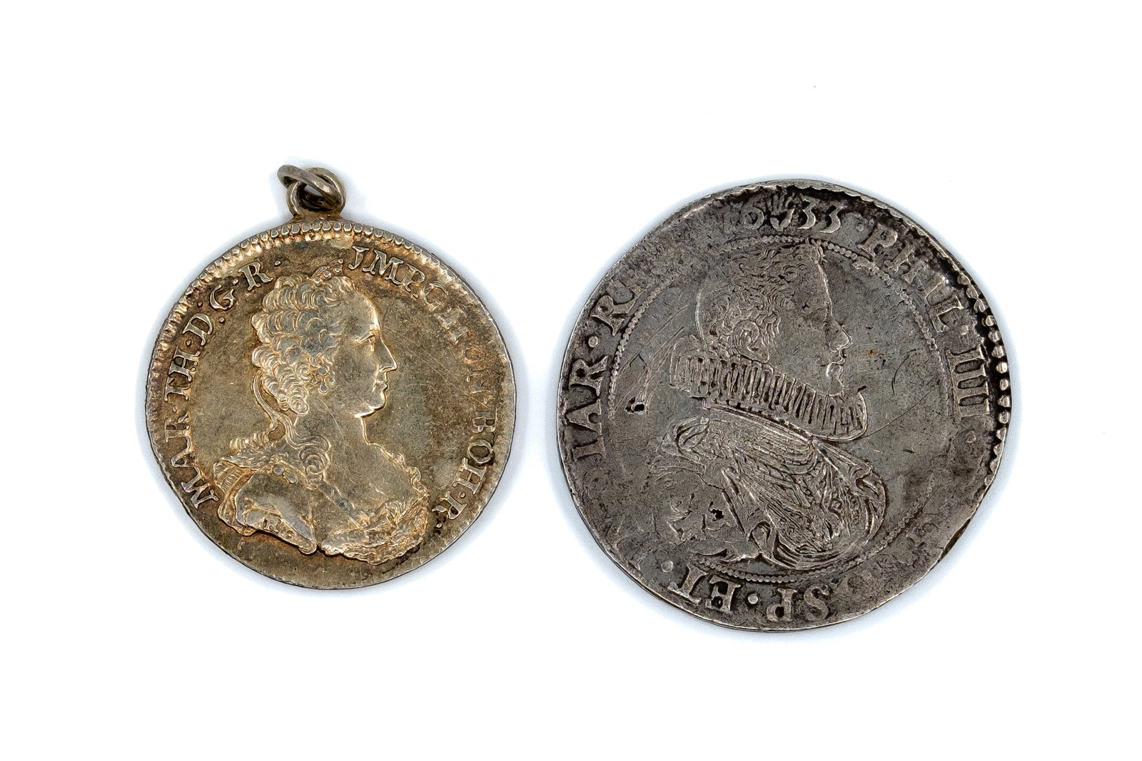 A pair of European silver coins of Maria Theresa and the Spanish Netherlands: A pair of European silver coins of Maria Theresa and the Spanish Netherlands. Comprising a Maria Theresa thaler dated 1753 with crowned double-headed eagle reverse, and a Spanish Netherlands issue dat