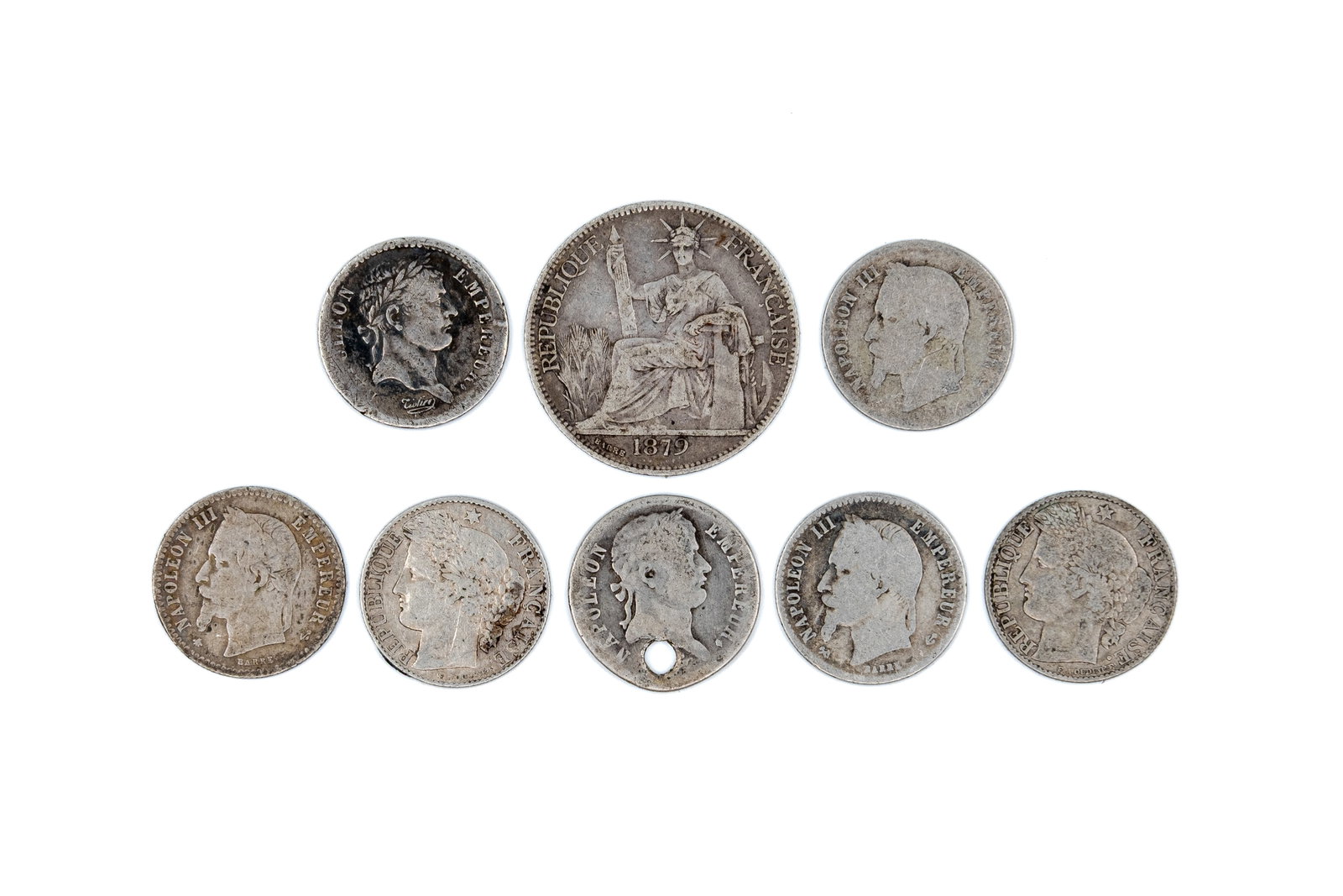 A lot of eight mixed French silver coins, dated 1812-1895: A lot of eight mixed French silver coins, dated 1812-1895. Comprising Demi Franc 1813, 20 Centimes 1879, 50 Centimes 1866, 1867, 1881 and 1895, and a coin of Napoleon I dated 1812, with denomination w