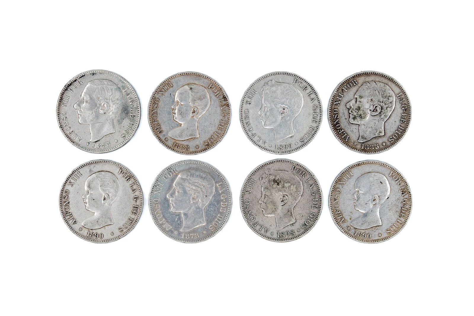 A lot of eight Spanish silver 5 Pesetas coins of Alfonso XIII, dated 1878-1899: A lot of eight Spanish silver 5 Pesetas coins of Alfonso XIII, dated 1878-1899. Comprising various portrait types of Alfonso XIII (including child and adult portraits) with crowned Spanish coat of arm