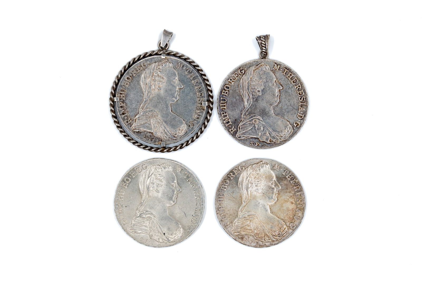 A lot of four Austrian silver coins, large denomination issues of Maria Theresa, dated 1780: A lot of four Austrian silver coins, large denomination issues of Maria Theresa, dated 1780. Featuring the bust of Maria Theresa on the obverse and the imperial double-headed eagle with crowned shield