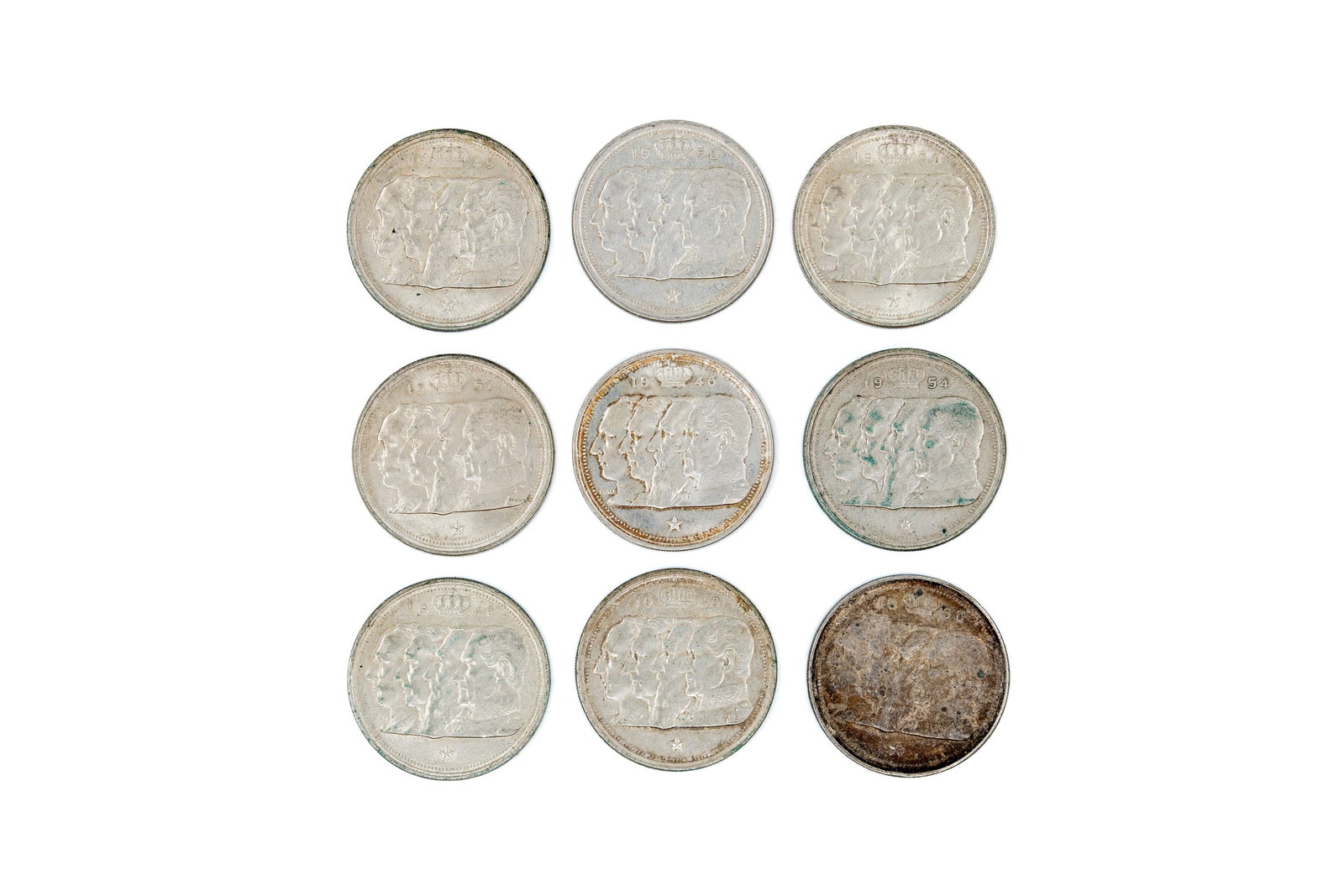 A lot of nine Belgian silver 100 francs coins, dated 1948-1954: A lot of nine Belgian silver 100 francs coins, dated 1948-1954. Comprising issues with four conjoined portraits of the Belgian royal family on the obverse and crowned coat of arms reverse. Total weigh
