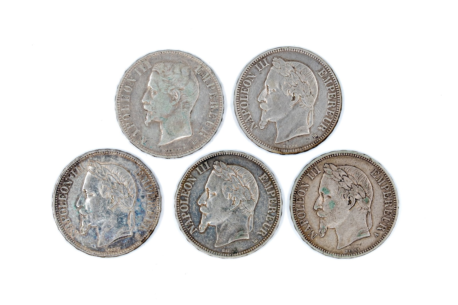 A lot of five French silver 5 francs coins of Napoleon III, dated 1856-1870: A lot of five French silver 5 francs coins of Napoleon III, dated 1856-1870. Comprising issues with bare and laureate head portraits on the obverse and imperial coat of arms reverse. Total weight: 124