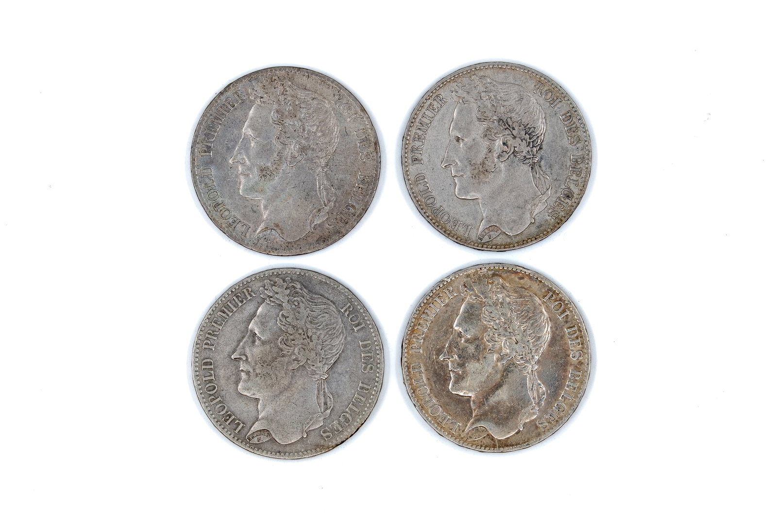 A lot of four Belgian silver 5 francs coins of Leopold I, dated 1835-1849: A lot of four Belgian silver 5 francs coins of Leopold I, dated 1835-1849. All issues with portrait of Leopold I on the obverse and wreath with denomination reverse. Weight: 25 - 24,9 - 24,8 - 24,8g