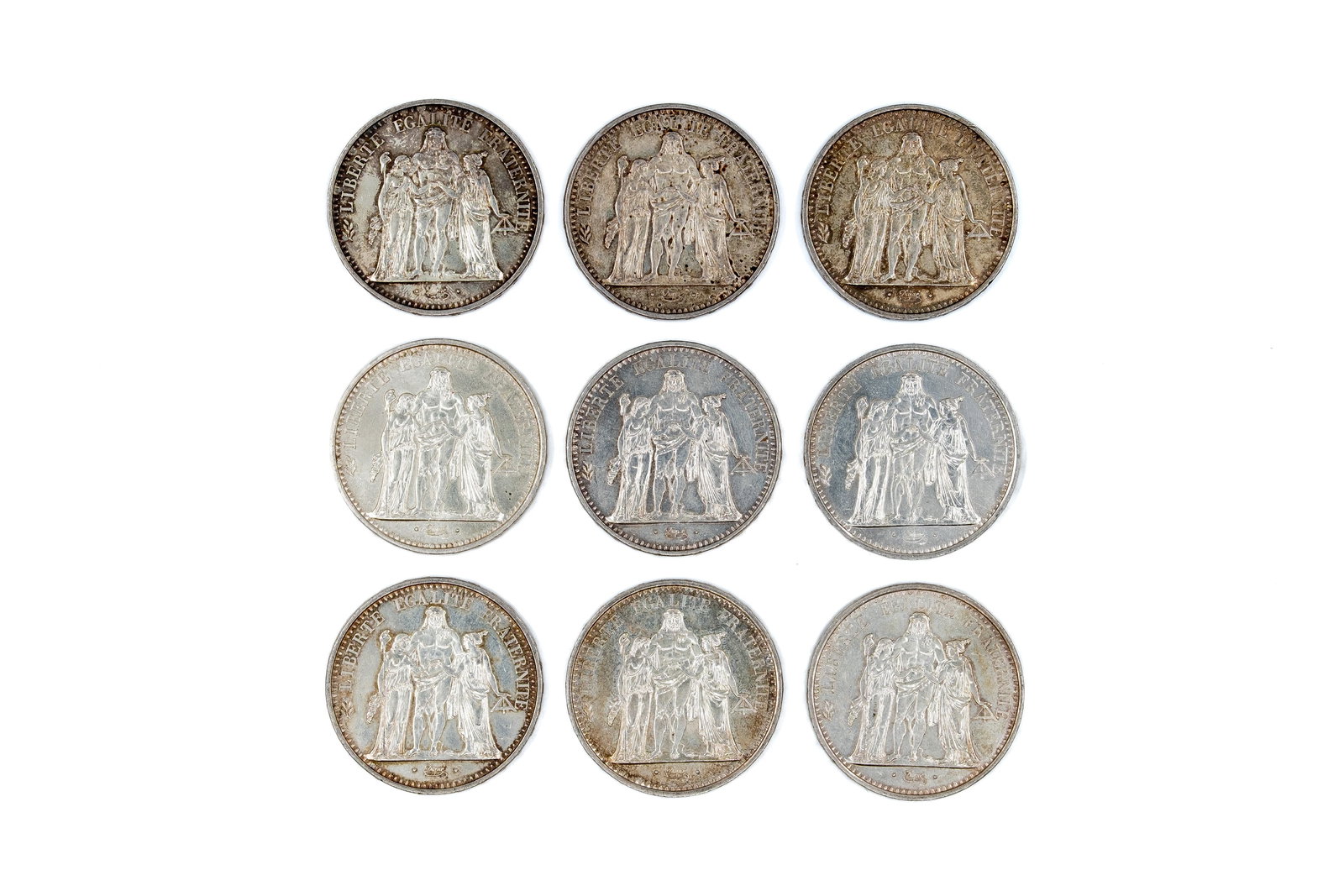 A lot of nine French silver 10 Francs coins, Third Republic, dated 1965-1968: A lot of nine French silver 10 Francs coins, Third Republic, dated 1965-1968. Obverse depicting the Hercules group (Liberty, Equality, Fraternity), reverse with wreath and denomination. Total weight: 