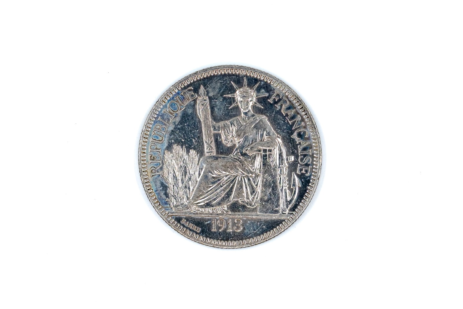 A French Indochina silver Piastre de Commerce, dated 1913: A French Indochina silver Piastre de Commerce, dated 1913. Issued for French Indo-China, with seated Republic reverse and wreath design enclosing the denomination. Weight: 27g