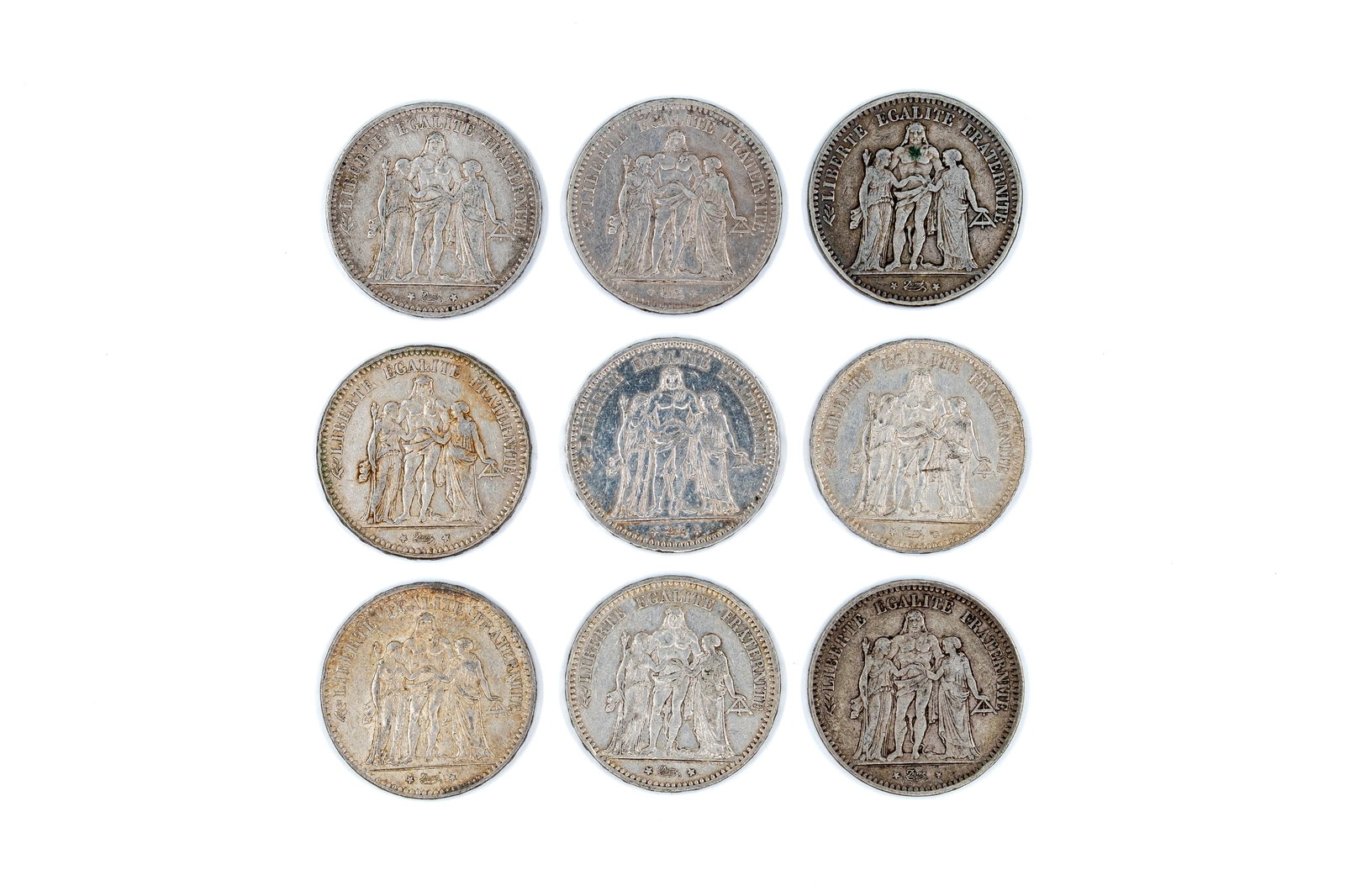 A lot of nine French silver 5 Francs coins, Third Republic, dated 1948-1977: A lot of nine French silver 5 Francs coins, Third Republic, dated 1948-1977. Obverse depicting the Hercules group (Liberty, Equality, Fraternity), reverse with wreath and denomination. Total weight: 2