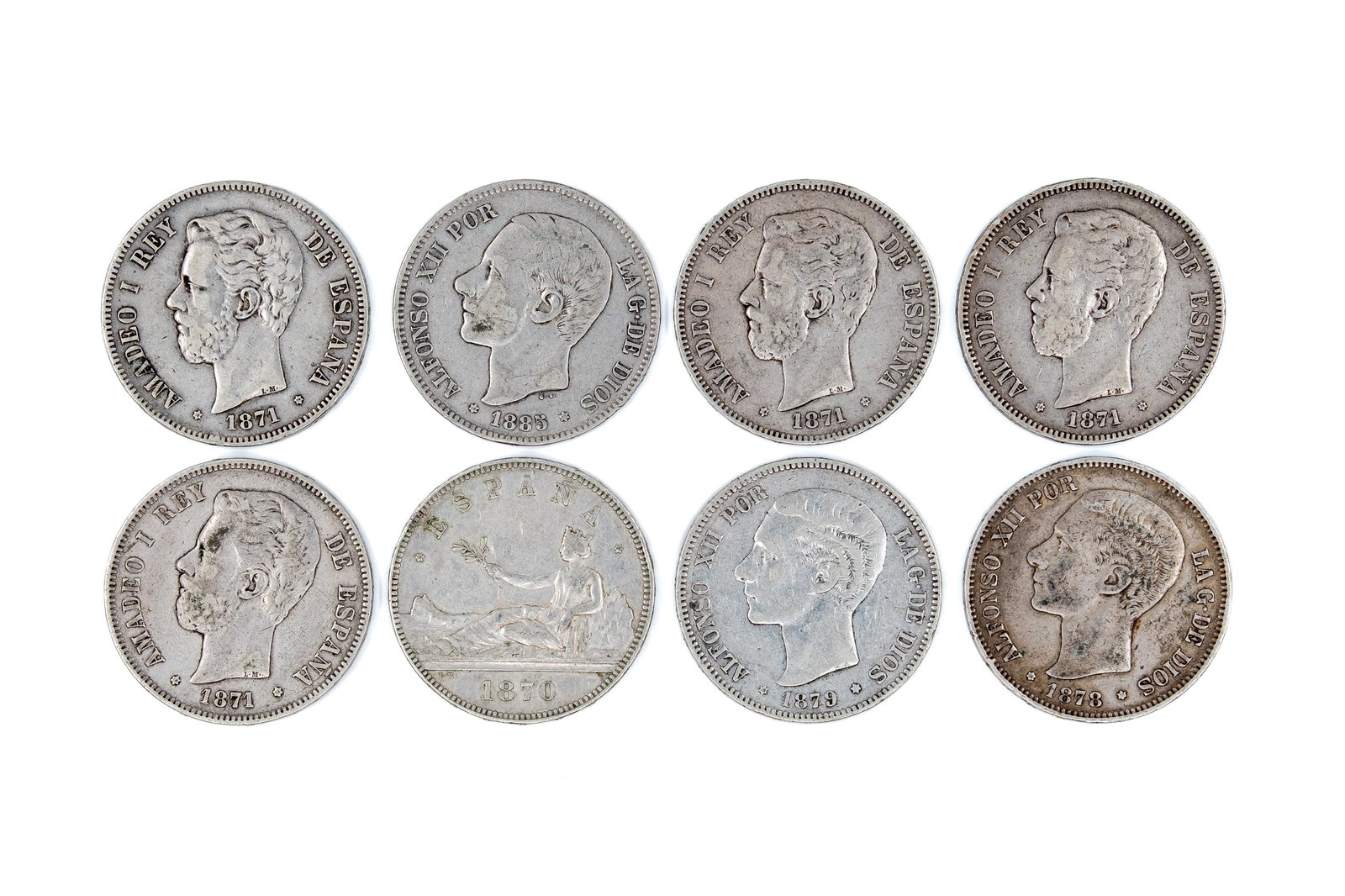 A lot of eight Spanish silver 5 Pesetas coins of various kings, dated 1870-1879.: A lot of eight Spanish silver 5 Pesetas coins of Amadeo I and Alfonso XII, dated 1870-1879. Comprising issues of Amadeo I and Alfonso XII and one type with seated allegorical female figure, all with c