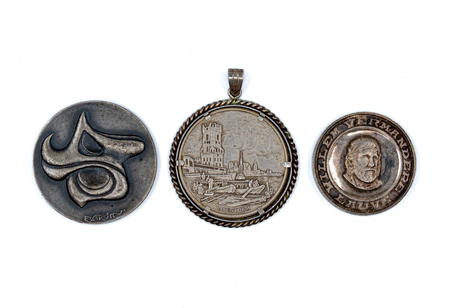 A lot of three silver medals and pendants, including Belgian and commemorative issues: A lot of three silver medals and pendants, including Belgian and commemorative issues. Comprising various pieces with portrait busts, architectural scenes and decorative motifs, including a mounted pe