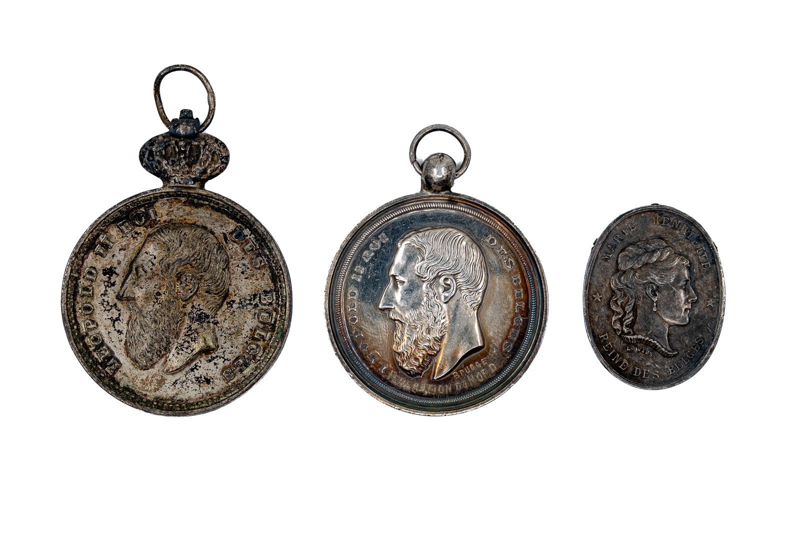 A lot of three Belgian silver medals and pendants of Leopold II and Marie Henriette: A lot of three Belgian silver medals and pendants of Leopold II and Marie Henriette. Comprising portrait issues of the Belgian royal family, including pendant types with commemorative inscriptions and