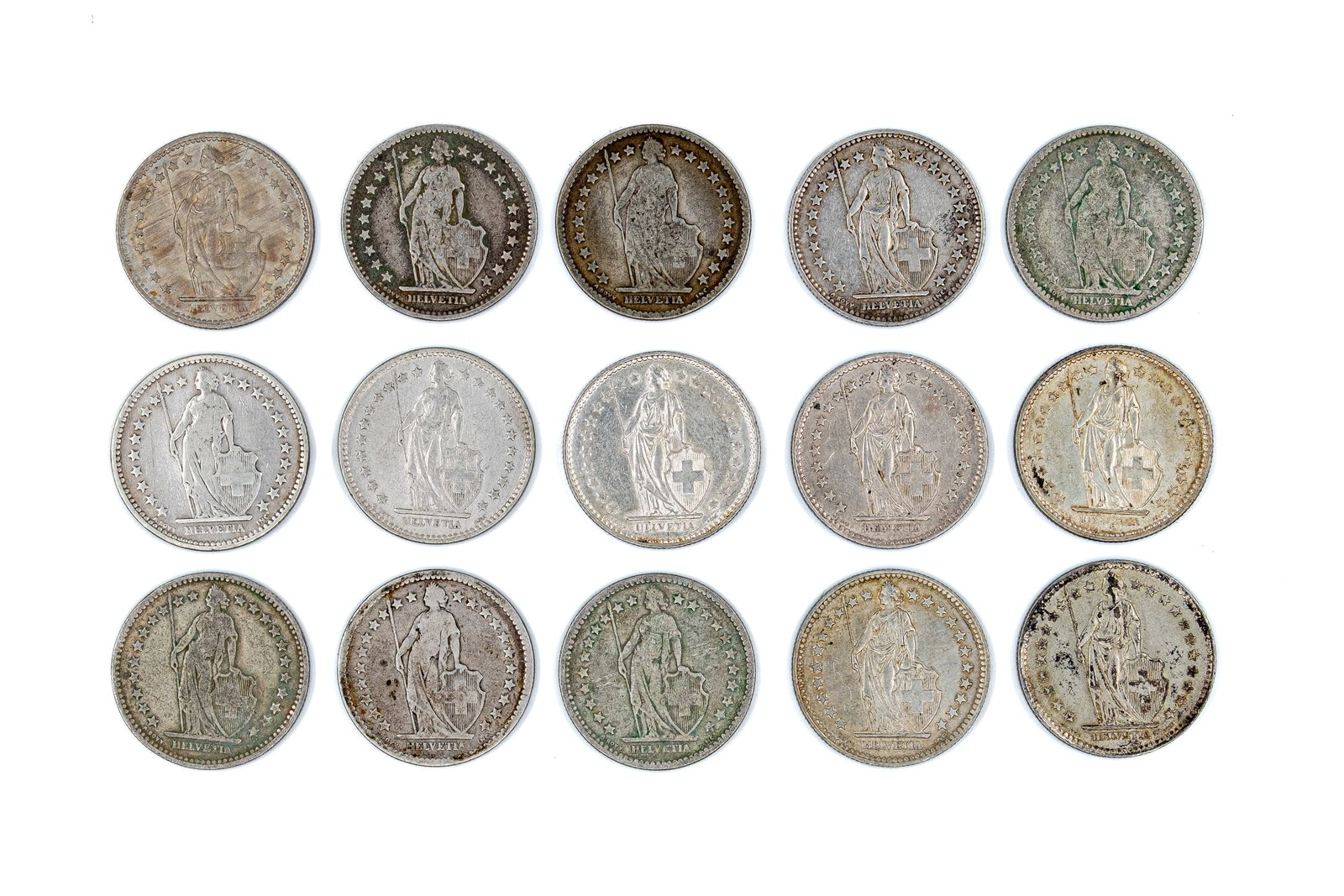 A lot of 15 Swiss silver 2 Francs coins, dated 1874-1969: A lot of 15 Swiss silver 2 Francs coins, dated 1874-1969. Comprising Helvetia standing type issues, with denominations within wreaths on the reverse. Total weight: 146,4g