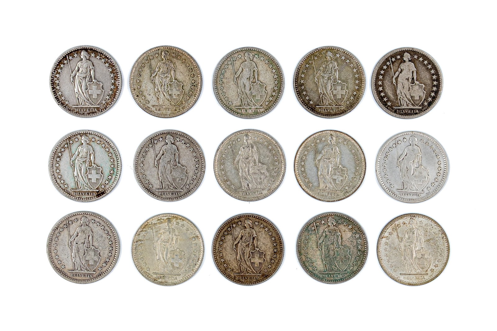 A lot of 15 Swiss silver 2 Francs coins, dated 1874-1967: A lot of 15 Swiss silver 2 Francs coins, dated 1874-1967. Comprising Helvetia standing type issues, with denominations within wreaths on the reverse. Total weight: 148,5g
