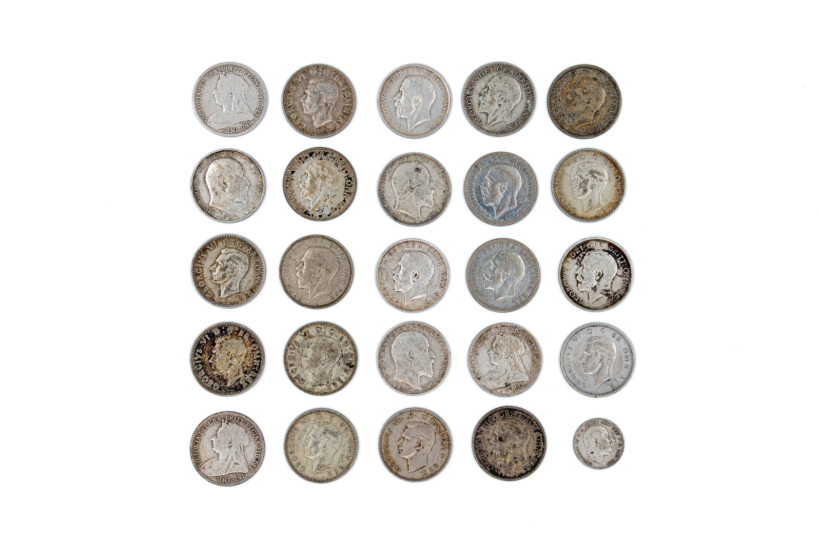A lot of 25 British silver coins, mainly shillings, featuring issues of various leaders: A lot of 25 British silver coins, mainly shillings, featuring issues of Victoria, Edward VII, George V and George VI. Comprising various portrait types with crowned lion and shield reverse designs. Da
