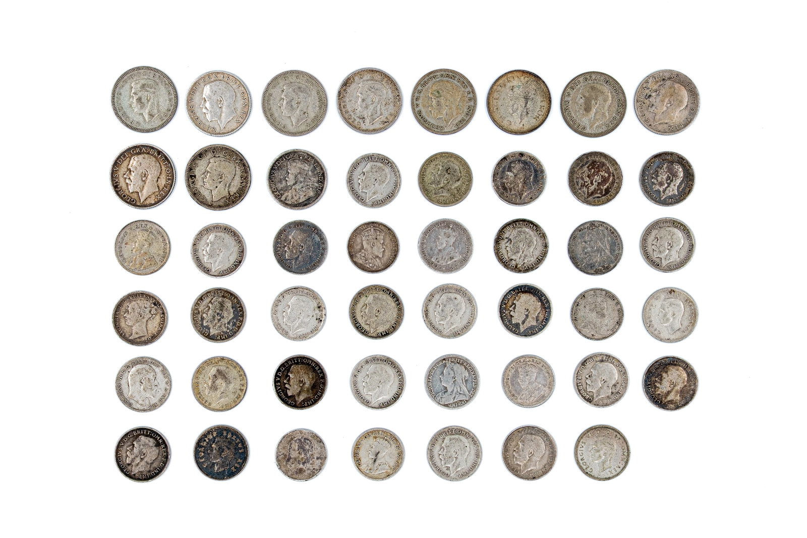 A lot of 47 British and Commonwealth silver coins, including issues of various leaders: A lot of 47 British and Commonwealth silver coins, including issues of Victoria, Edward VII, George V and George VI. Comprising shillings, sixpences and smaller denominations, with various crowned and