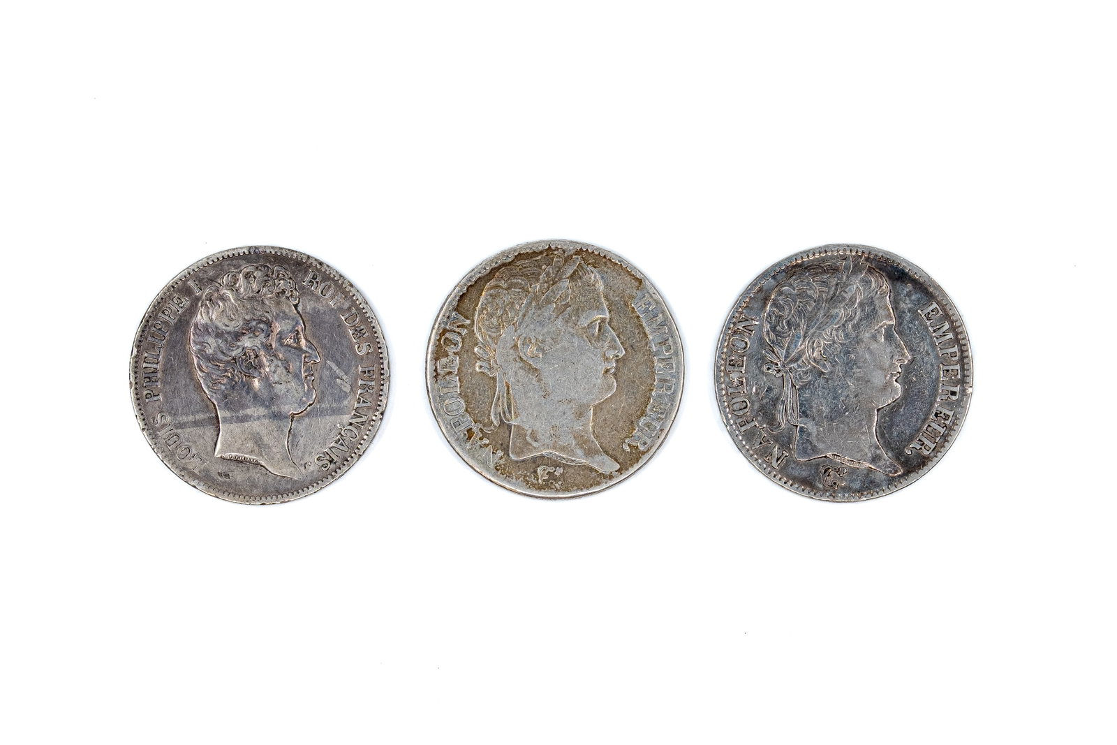 A lot of three French silver 5 Francs coins of various leaders, dated 1812-1831: A lot of three French silver 5 Francs coins of Louis Philippe I and Napoleon I, dated 1812-1831. Comprising 2 issues of Napoleon I and 1 of Louis Philippe I, with wreath reverse and denomination withi