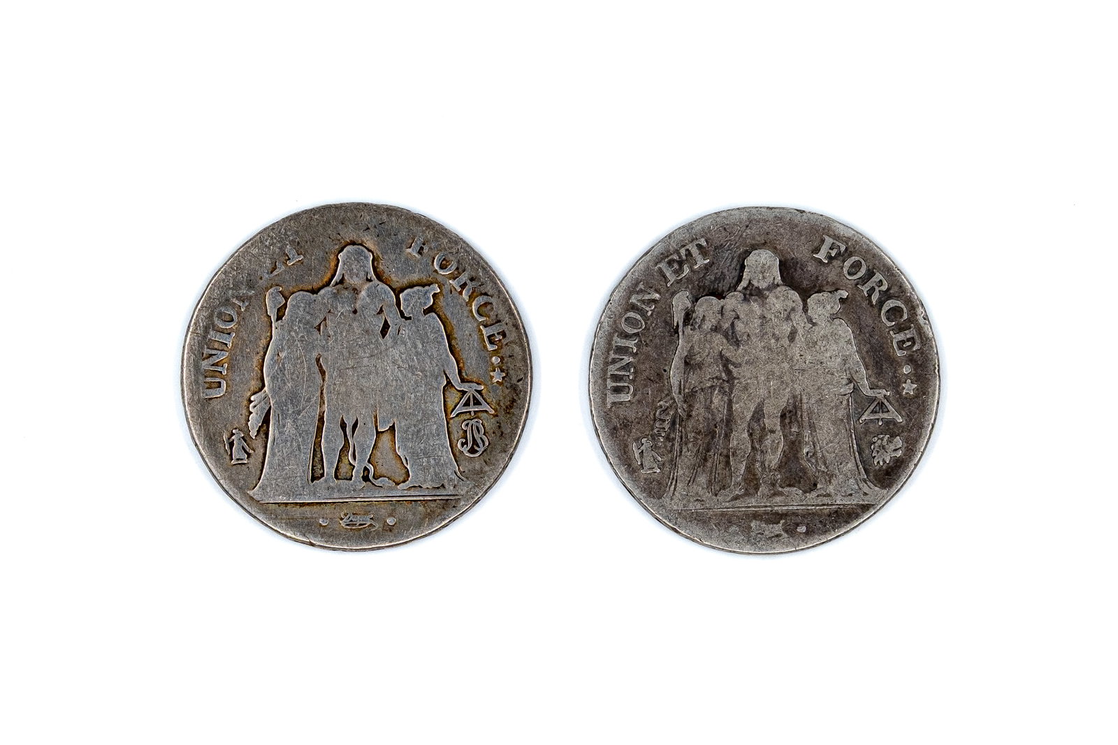 A lot of two French silver 5 Francs coins of the Revolutionary period: A lot of two French silver 5 Francs coins of the Revolutionary period, dating from the turn of the 18th to the 19th century. Comprising early Republican issues with Union et Force design and wreath re