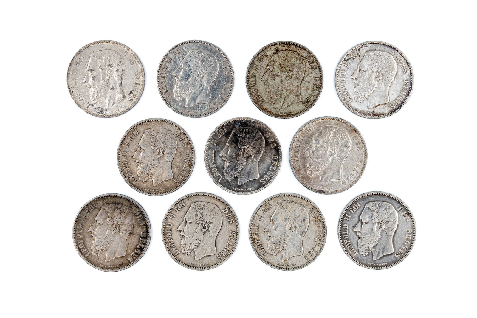 A lot of 11 Belgian silver 5 Francs coins of Leopold II, dated 1868-1873: A lot of 11 Belgian silver 5 Francs coins of Leopold II, dated 1868-1873. All Belgian silver issues with crowned shield reverse within wreath. Total weight: 273,7g