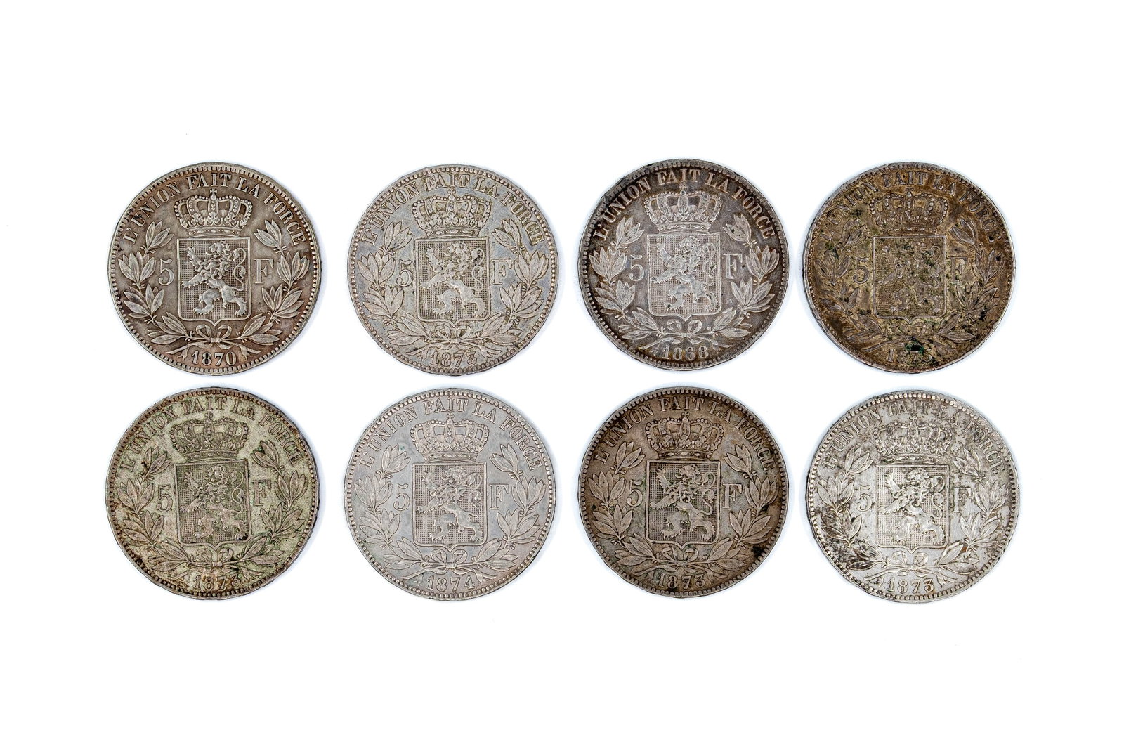 A lot of eight Belgian silver 5 Francs coins of Leopold II, dated 1868-1874: A lot of eight Belgian silver 5 Francs coins of Leopold II, dated 1868-1874. All Belgian silver issues with crowned shield reverse within wreath. Total weight: 199,8g
