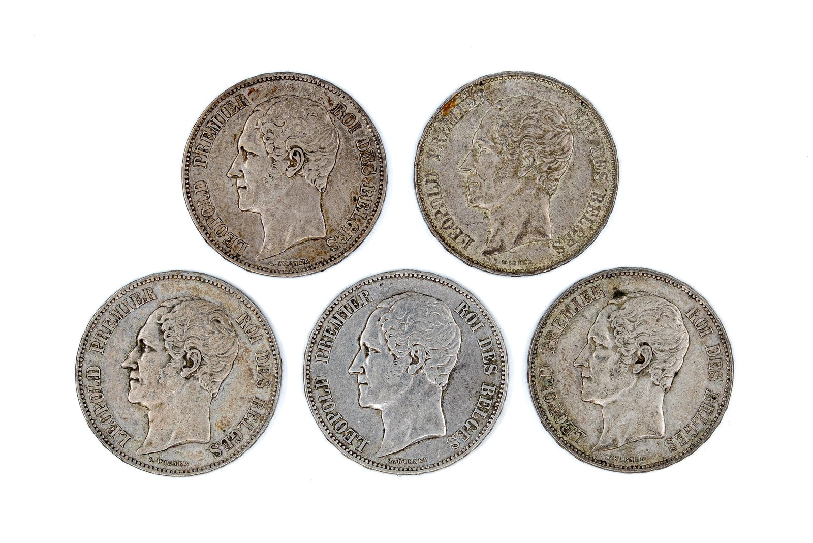 A lot of five Belgian silver 5 Francs coins of Leopold I, dated 1851-1853: A lot of five Belgian silver 5 Francs coins of Leopold I, dated 1851-1853. All portrait issues with crowned shield reverse within wreath. Total weight: 124,7g