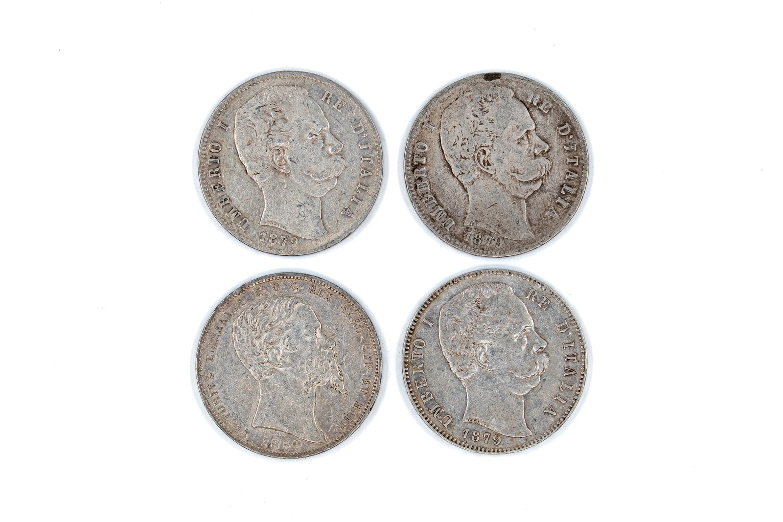 A lot of four Italian silver 5 Lire coins of various kings, dated 1850-1879: A lot of four Italian silver 5 Lire coins of Vittorio Emanuele II and Umberto I, dated 1850-1879. Comprising royal portrait issues, with crowned shield reverse within wreath. Weight: 24,9 - 24,8 - 24,