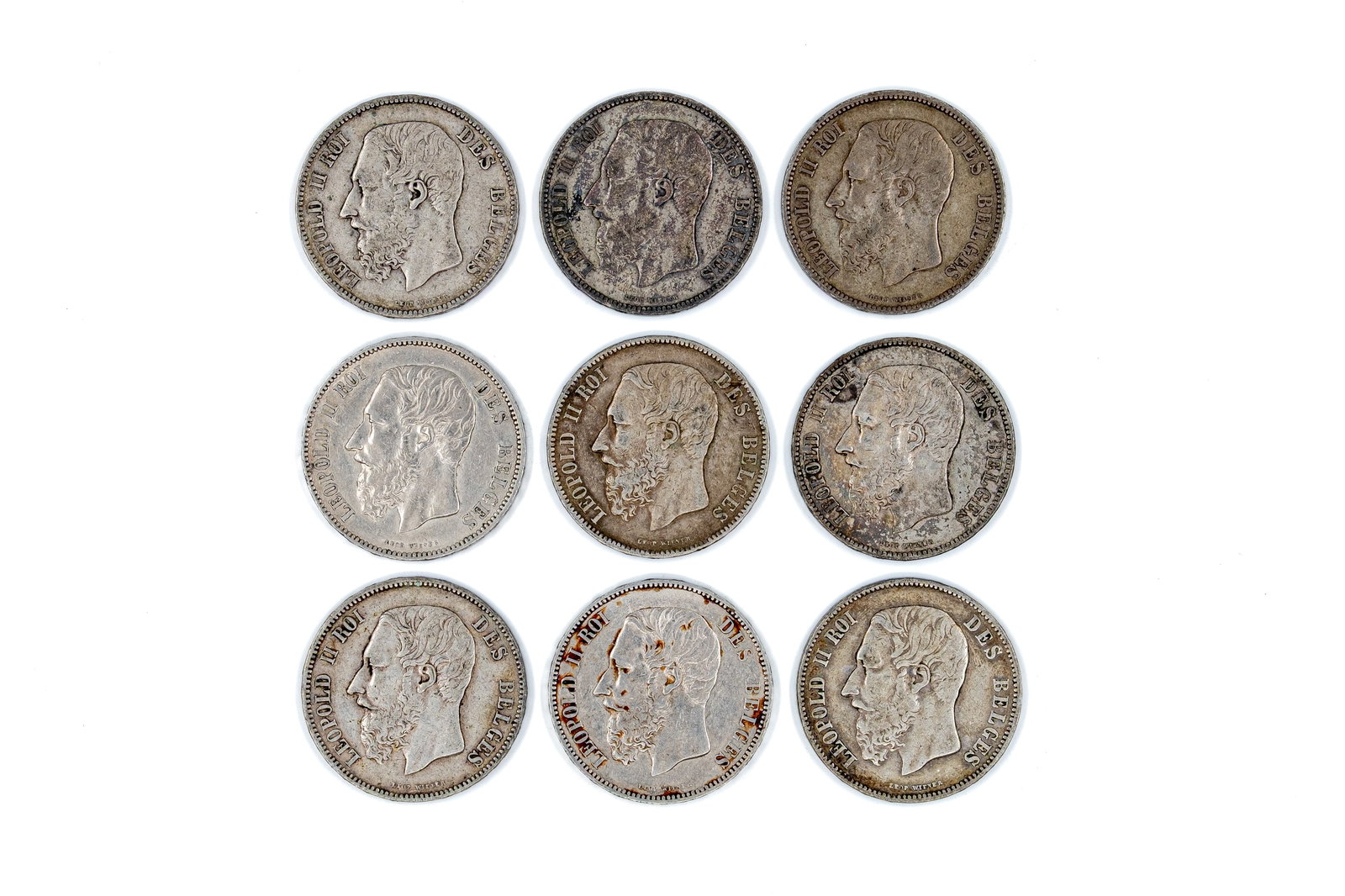 A lot of nine Belgian silver 5 Francs coins of Leopold II, dated 1867-1876: A lot of nine Belgian silver 5 Francs coins of Leopold II, dated 1867-1876. Comprising all silver issues with crowned shield reverse within wreath. Total weight: 223,6g
