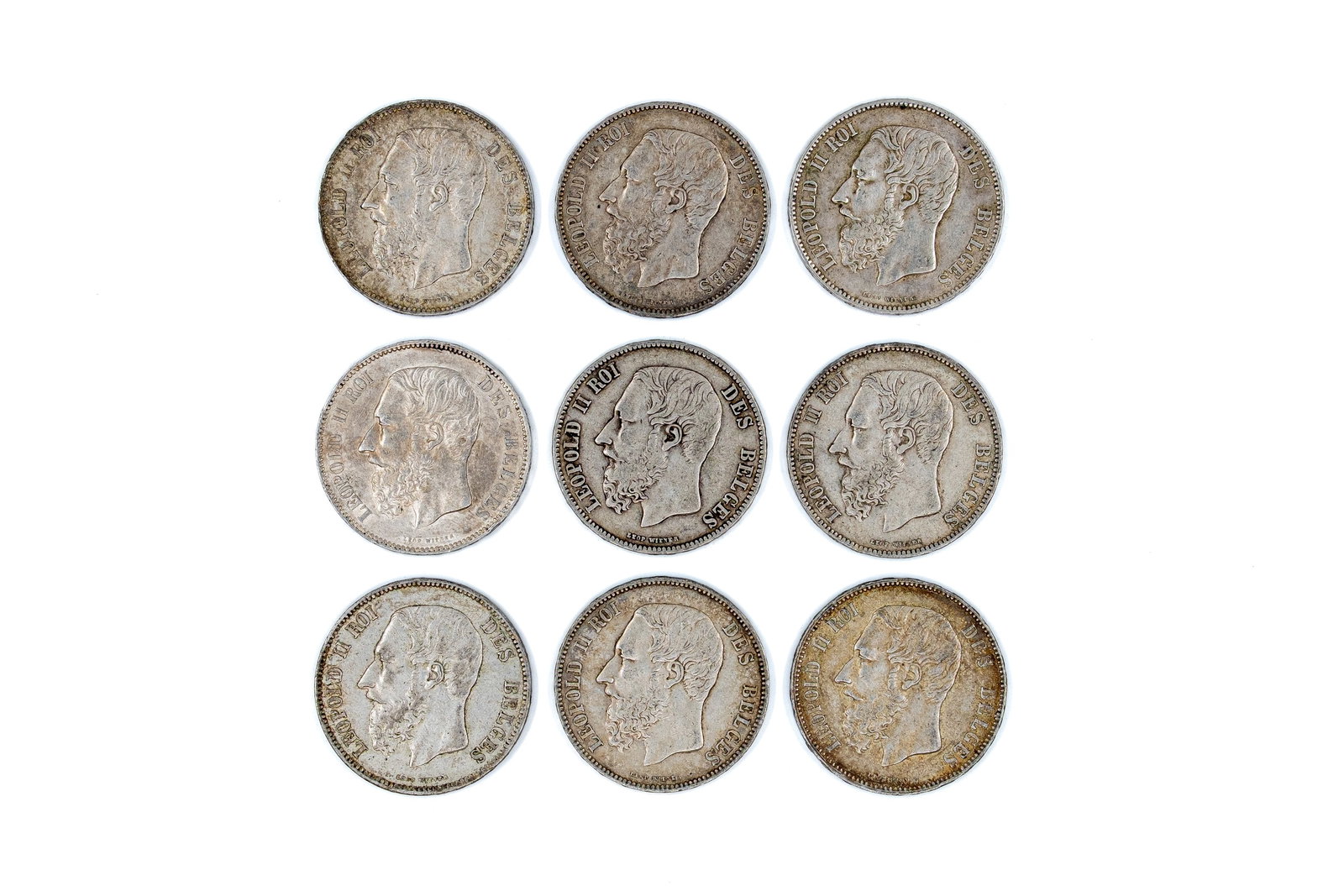 A lot of nine Belgian silver 5 Francs coins of Leopold II, dated 1867-1873: A lot of nine Belgian silver 5 Francs coins of Leopold II, dated 1867-1873. Comprising all silver issues with crowned shield reverse within wreath. Total weight: 224,6g