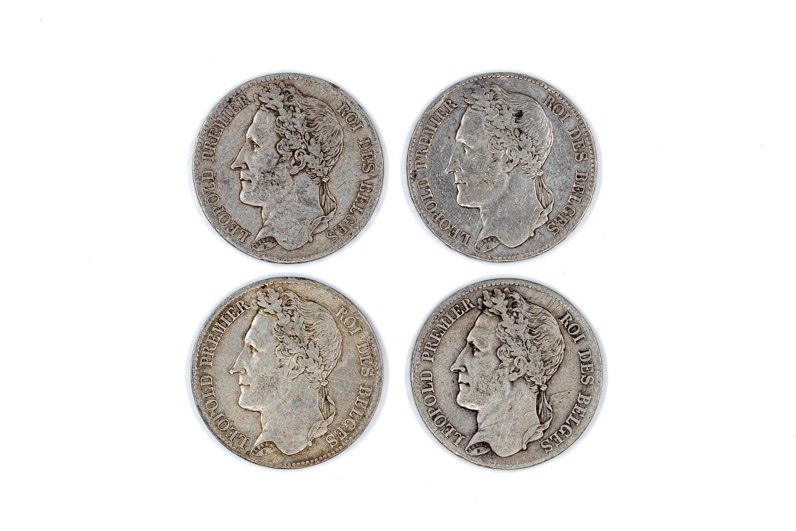 A lot of four Belgian silver 5 Francs coins of Leopold I, dated 1833-1848: A lot of four Belgian silver 5 Francs coins of Leopold I, dated 1833-1848. Comprising all silver issues with wreath reverse and denomination within. Weight: 24,9 - 24,9 - 24,9 - 24,8g