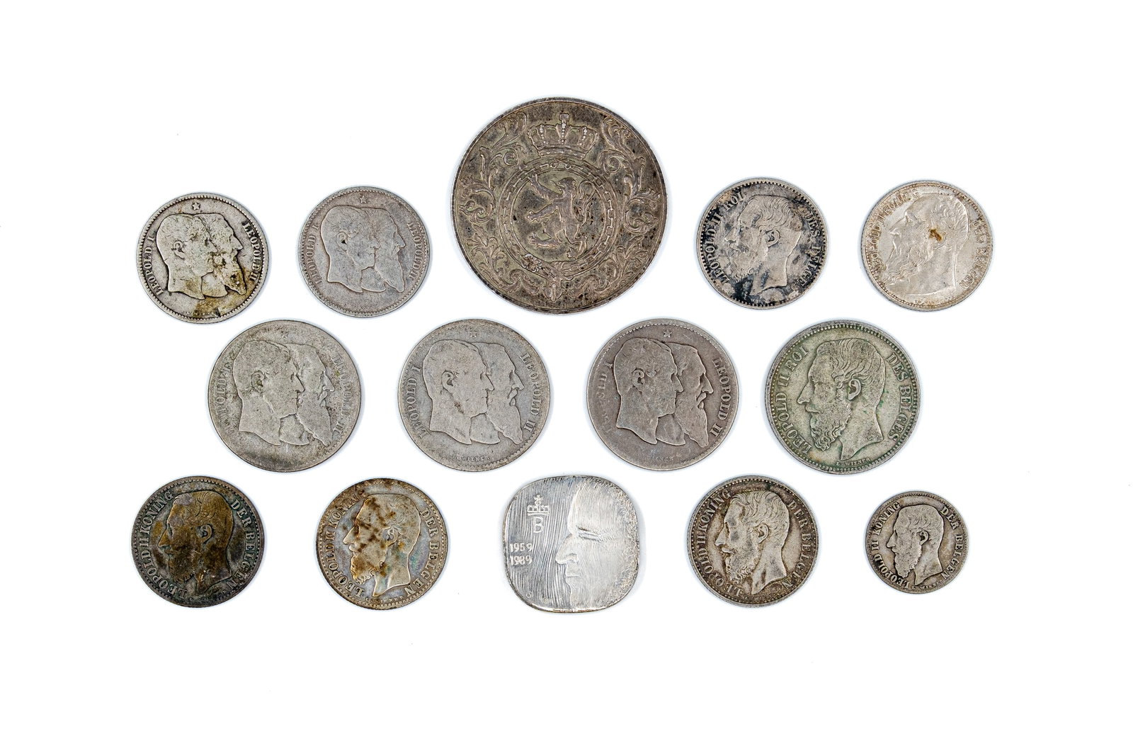 A lot of 14 Belgian coins and tokens, 19th-20th century: A lot of 14 Belgian coins and tokens, 19th-20th century. Comprising mainly issues of Leopold I and Leopold II, together with circulation and commemorative pieces in various denominations, with royal p