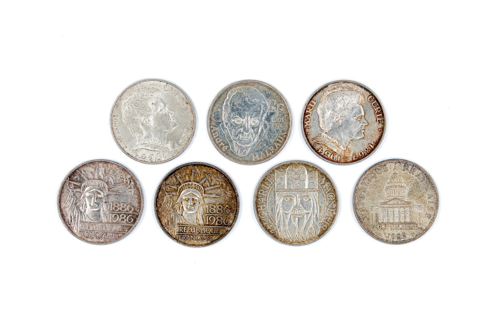 A lot of seven French silver 100 Francs commemorative coins, 20th century: A lot of seven French silver 100 Francs commemorative coins, 20th century. Comprising commemorative issues with portraits and allegorical motifs on the obverse, and denomination designs and symbolic r