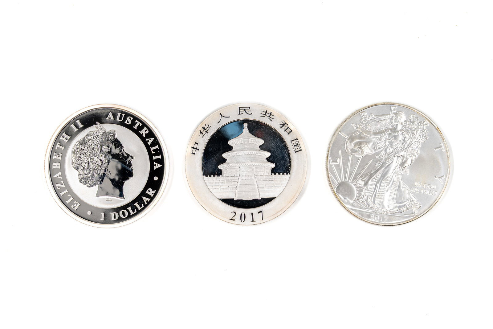 A lot of three modern silver coins, dated 2017: A lot of three modern silver coins, dated 2017. Comprising an Australian Kookaburra one dollar, a Chinese Panda 10 yuan and a United States American Silver Eagle one dollar. Weight: 31,4 - 30 - 31,2g