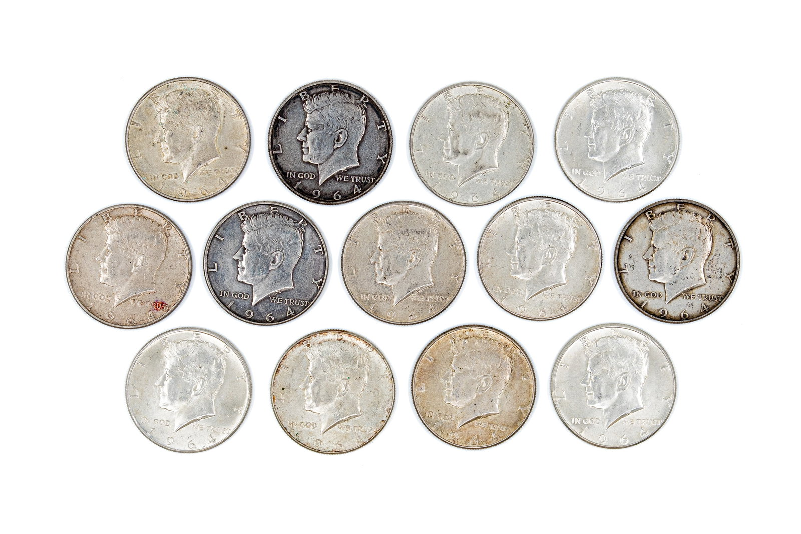 A lot of 13 United States silver Kennedy Half Dollars, dated 1964: A lot of 13 United States silver Kennedy Half Dollars, dated 1964. Comprising silver issues with the portrait of John F. Kennedy on the obverse, and the presidential eagle reverse. Total weight: 162,4
