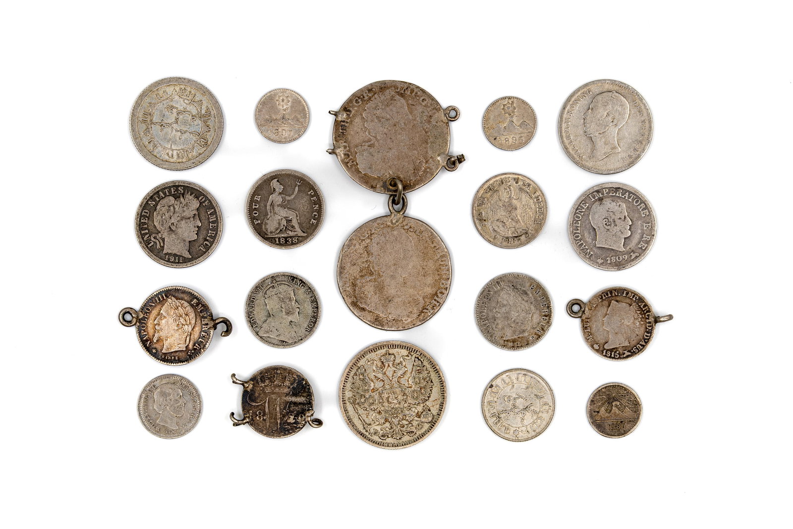 A lot of 19 silver coins and mounted coin elements, 19th-20th century: A lot of 19 silver coins and mounted coin elements, 19th-20th century. Comprising a mixed group of European and American issues, including several mounted pieces, with royal and imperial portraits, ar