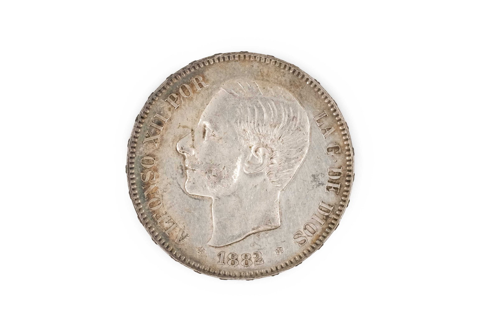 A Spanish silver 5 Pesetas coin of Alfonso XII, dated 1882: A Spanish silver 5 Pesetas coin of Alfonso XII, dated 1882. With bare head of the king facing left and legend, the reverse depicting crowned shield between pillars and denomination below. Weight: 25g