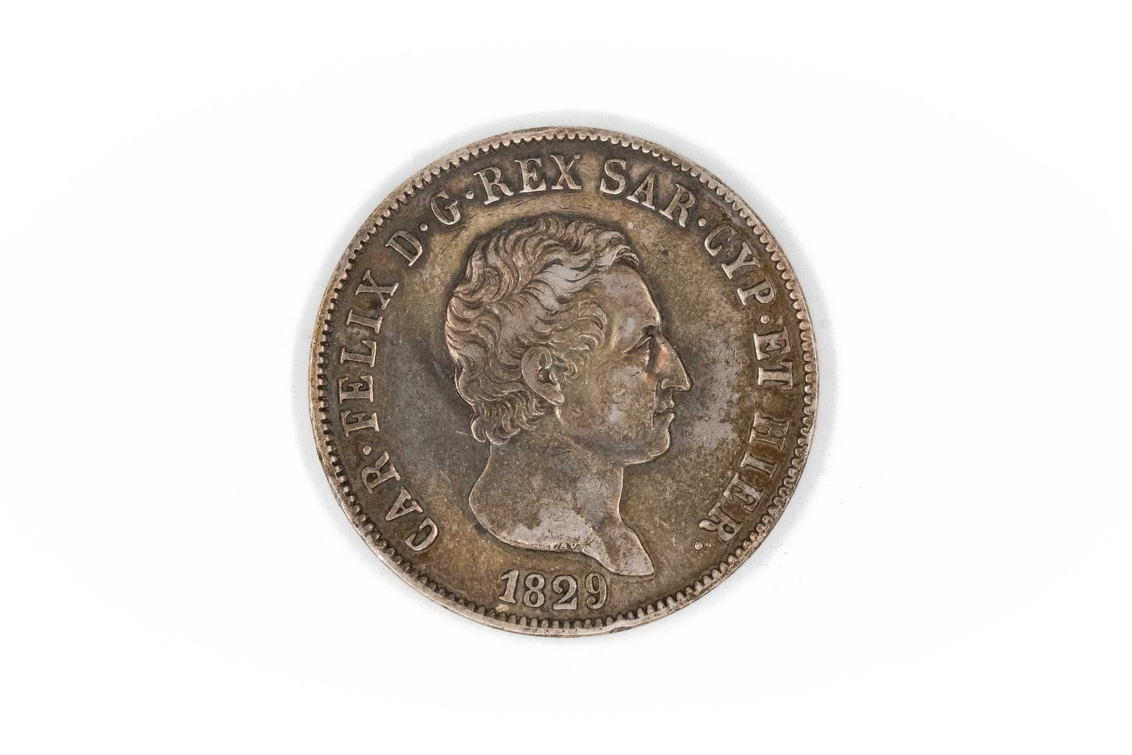 A Sardinian silver 5 Lire coin of Carlo Felice, dated 1829: A Sardinian silver 5 Lire coin of Carlo Felice, dated 1829. With bare head of the king facing right and legend, the reverse depicting crowned shield within wreath and denomination below. Weight: 24,9g