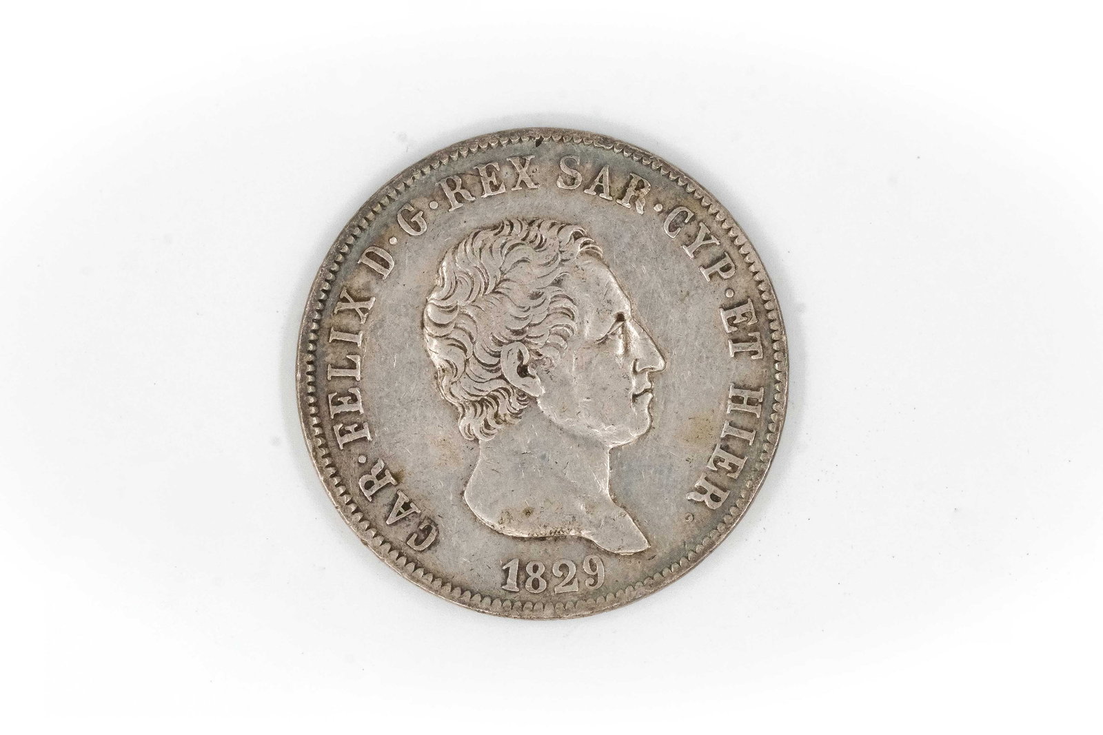 A Sardinian silver 5 Lire coin of Carlo Felice, dated 1829: A Sardinian silver 5 Lire coin of Carlo Felice, dated 1829. With bare head of the king facing right and legend, the reverse depicting crowned shield within wreath and denomination below. Weight: 24,6g