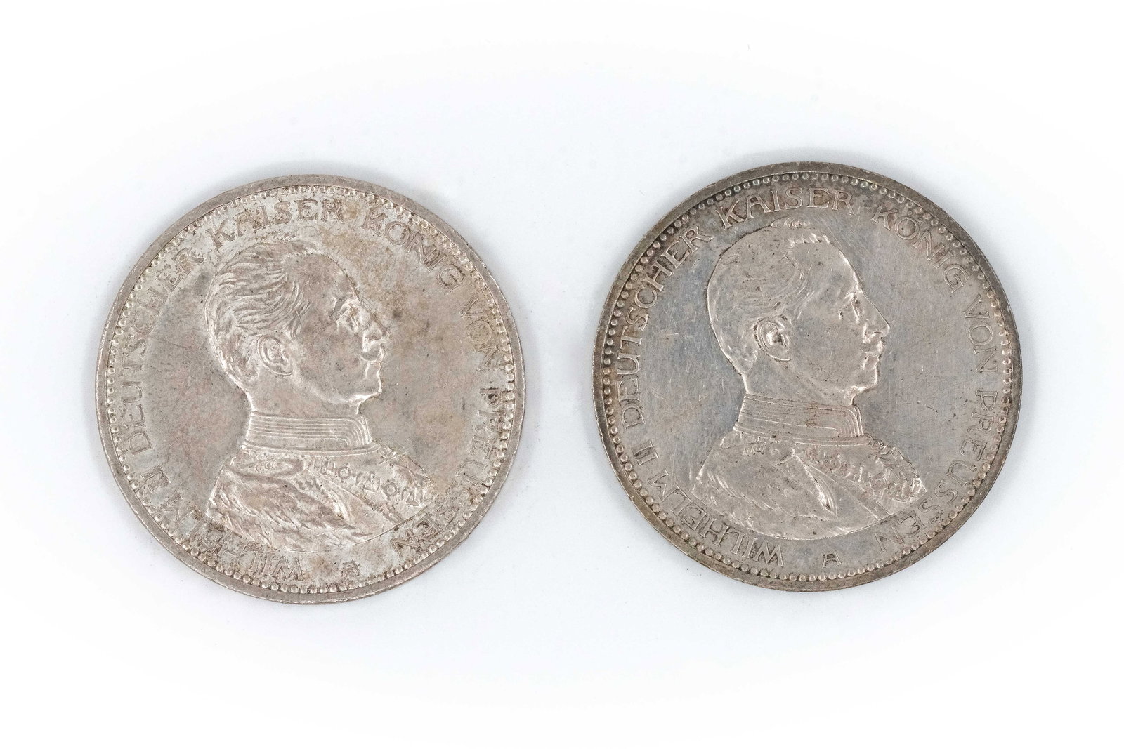 A lot of two German silver 5 Mark coins of Wilhelm II of Prussia, dated 1913 and 1914: A lot of two German silver 5 Mark coins of Wilhelm II of Prussia, dated 1913 and 1914. Both imperial issues with bust of the emperor facing right, the reverse depicting the imperial eagle and denomina