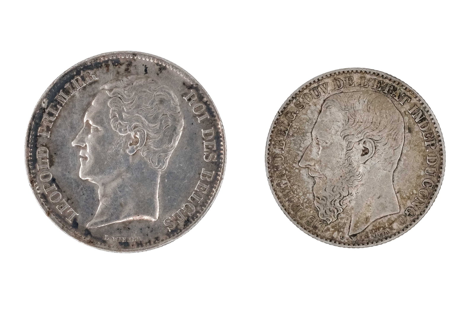 A lot of two Belgian silver coins, dated 1849 and 1887: A lot of two Belgian silver coins, dated 1849 and 1887. Comprising a 2½ Francs coin of Leopold I and a 2 Francs coin of Leopold II, with crowned shields within wreaths on the reverse. Weight: 1