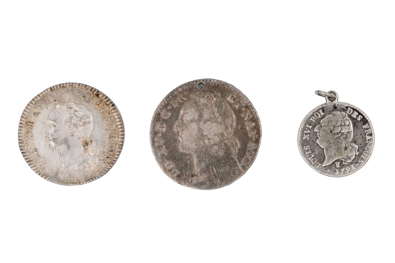 A lot of three European silver coins: A lot of three European silver coins. Comprising French issues and a coin of the Kingdom of Italy, together with a small 15 Sols pendant coin, with allegorical figure and crowned shield designs on the
