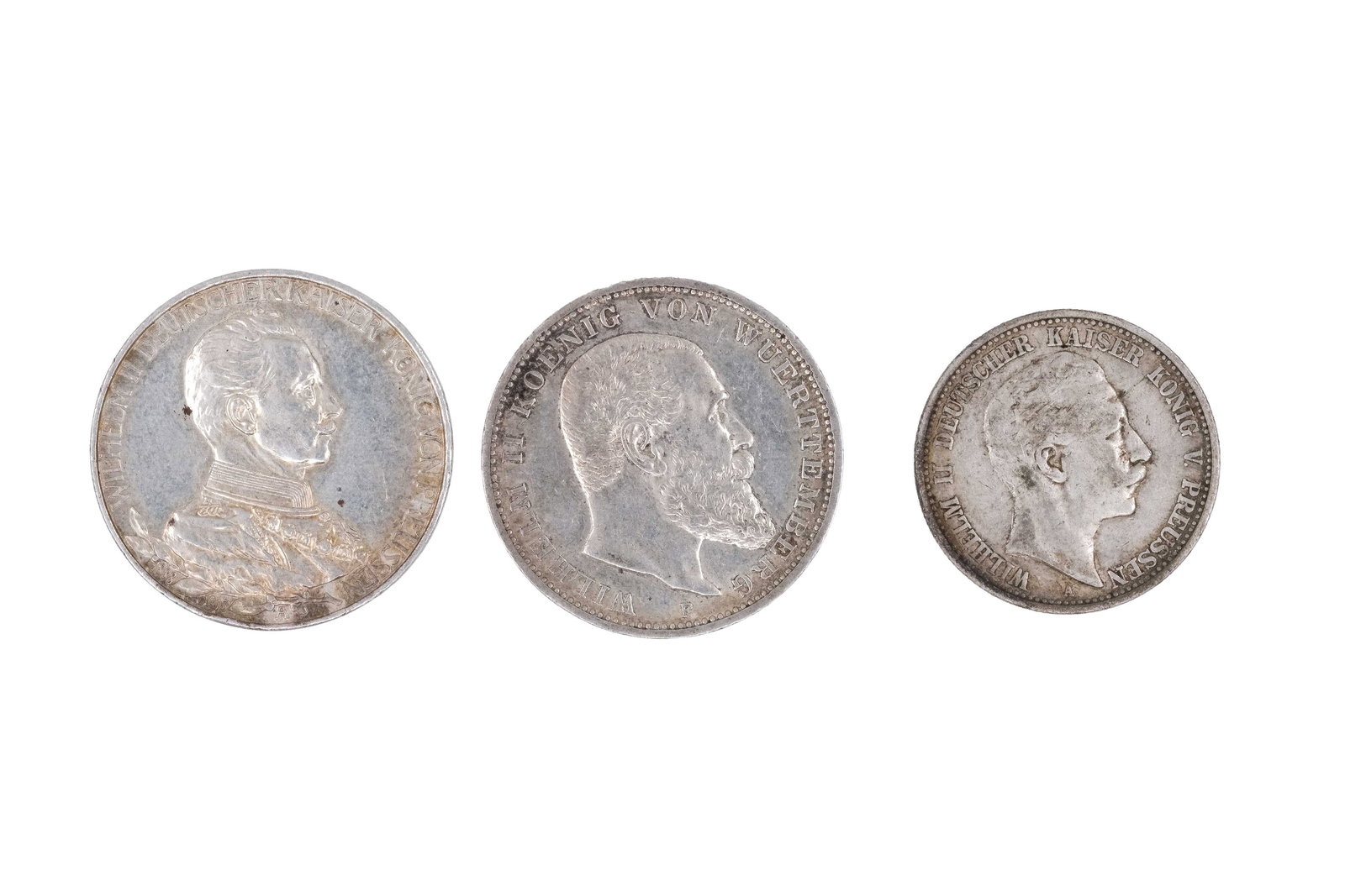 A lot of three German silver coins of Wilhelm II, dated 1903, 1913 and 1914: A lot of three German silver coins of Wilhelm II, dated 1903, 1913 and 1914. Comprising two 3 Mark coins and one 2 Mark coin, with imperial eagle reverses and bust of the emperor on the obverse. Weigh