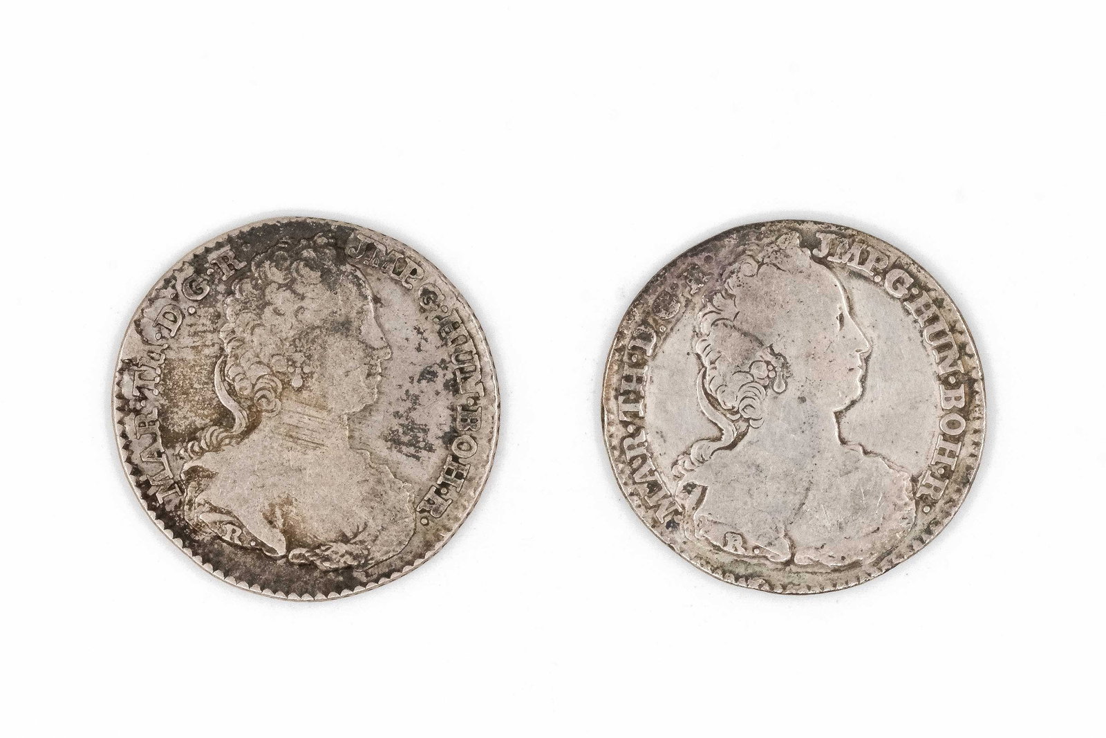 A lot of two Austrian silver coins of Maria Theresa, dated 18th century: A lot of two Austrian silver coins of Maria Theresa, dated 18th century. Both depicting the draped bust of Maria Theresa, with corresponding crowned double-headed eagle and armorial shield reverse. We