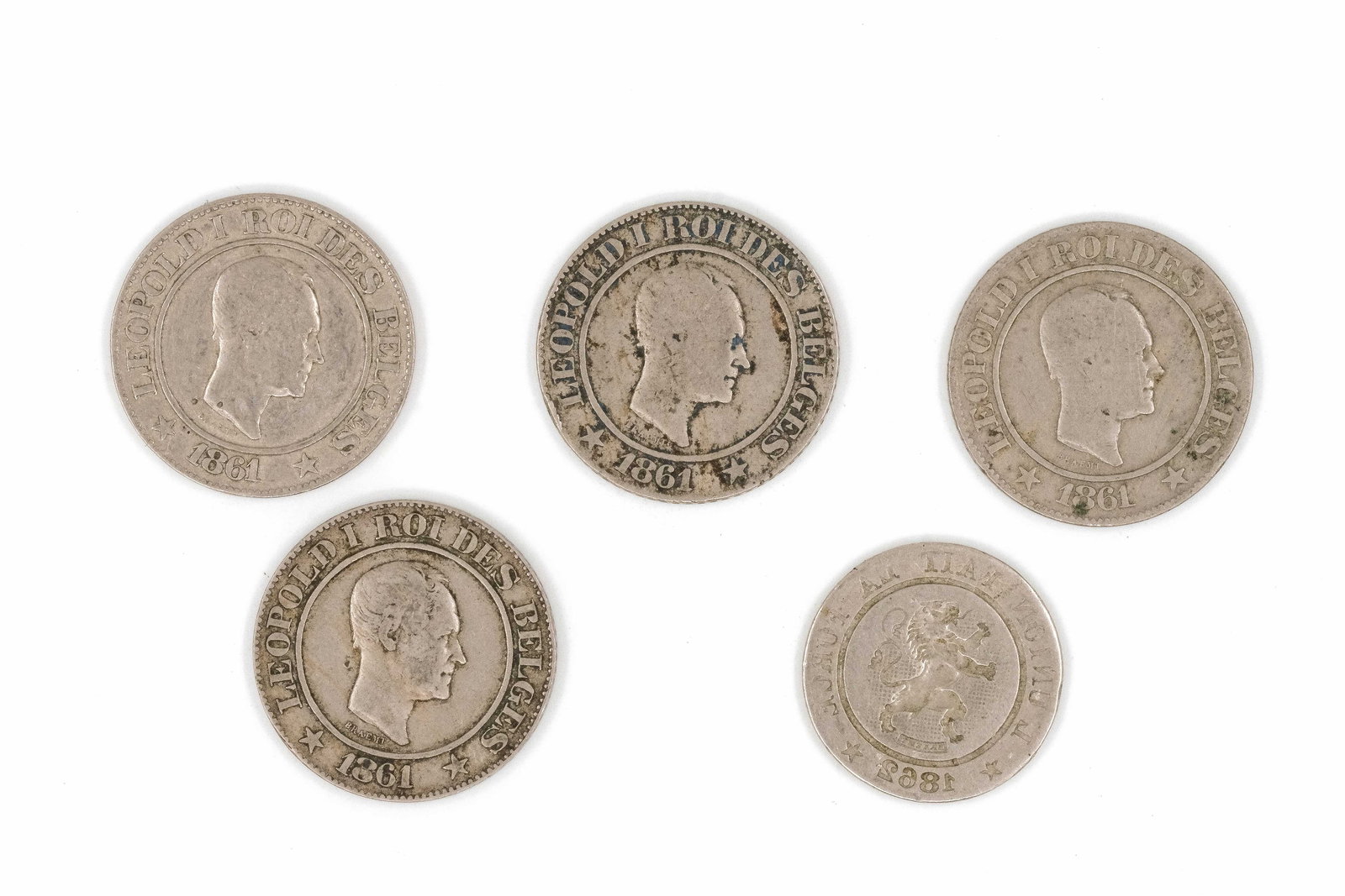 A lot of four Belgian silver 20 Centimes coins together with a rare brockage strike: A lot of four Belgian silver 20 Centimes coins together with a rare brockage strike. All 20 Centimes coins dated 1861, brockage strike dated 1862. Comprising four regular Leopold I 20 Centimes issues 