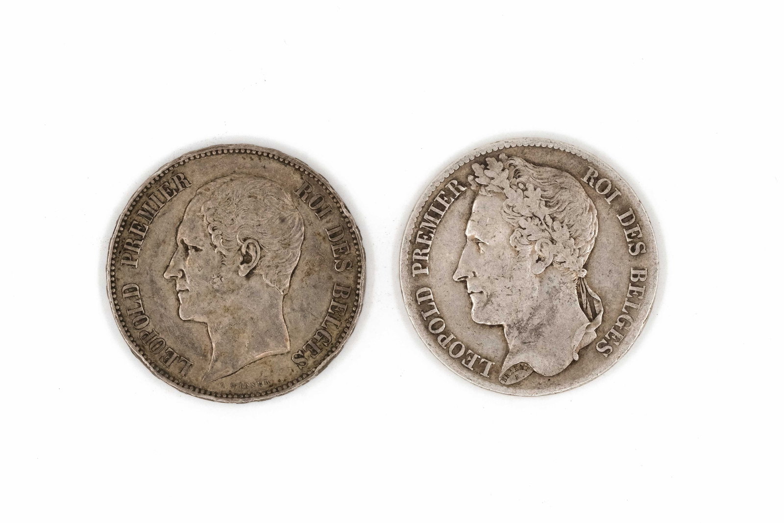A lot of two Belgian silver 5 Francs coins, dated 1833 and 1853: A lot of two Belgian silver 5 Francs coins, dated 1833 and 1853. Comprising an issue of Leopold I with laureate head and a commemorative-type coin depicting conjoined busts of Leopold I and Queen Loui