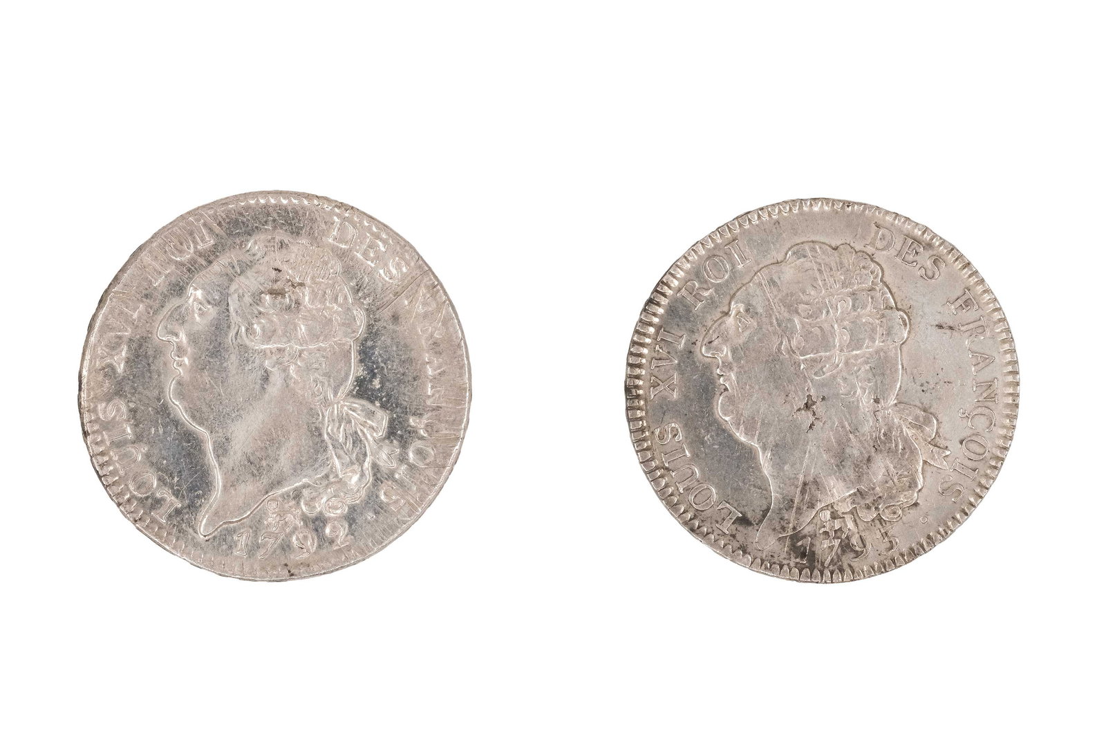 A lot of two French silver coins of Louis XVI, dated 1792 and 1793: A lot of two French silver coins of Louis XVI, dated 1792 and 1793. Both depicting the draped bust of Louis XVI, with reverse featuring the standing Genius inscribing the constitution and legend refer