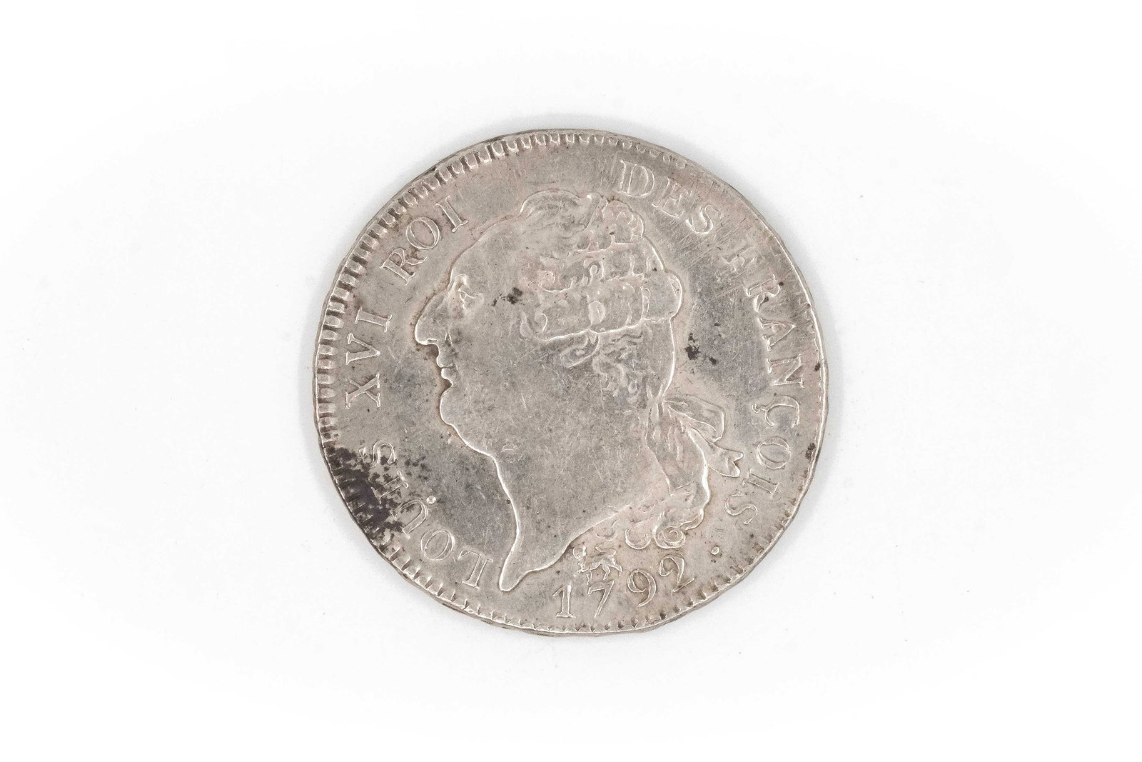 A French silver coin of Louis XVI, dated 1792: A French silver coin of Louis XVI, dated 1792. With draped bust of the king and reverse depicting a standing Genius inscribing the Constitution, dated L'AN 4 DE LA LIBERTÉ. Weight: 29,5g