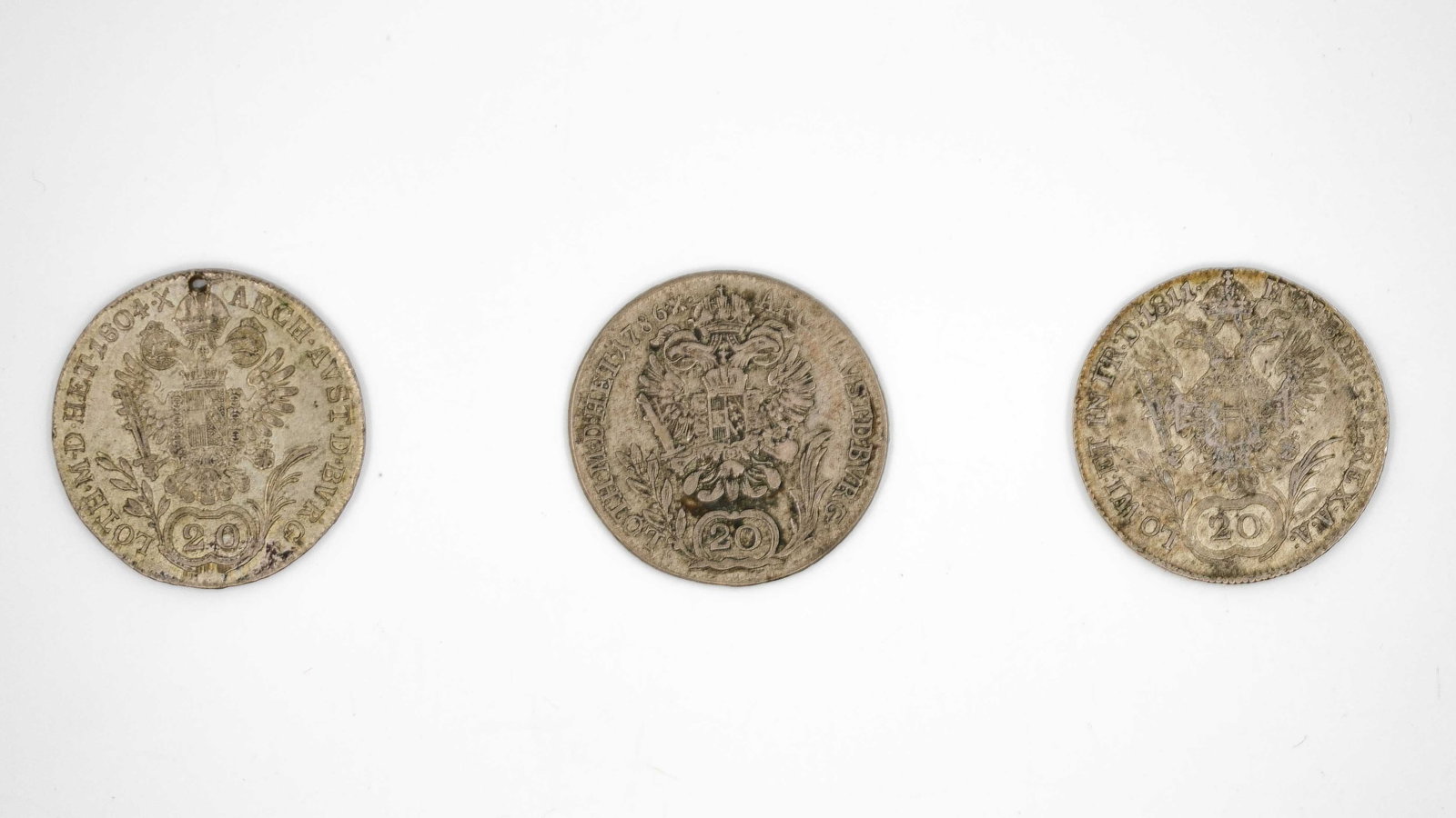 A lot of three Austrian silver coins of 20 kreuzer, dated 1786, 1804 and 1811: A lot of three Austrian silver coins of 20 kreuzer, dated 1786, 1804 and 1811. Each with crowned double-headed eagle on the obverse and laureate bust on the reverse. Weight: 6,7 - 6,6 - 6,7g