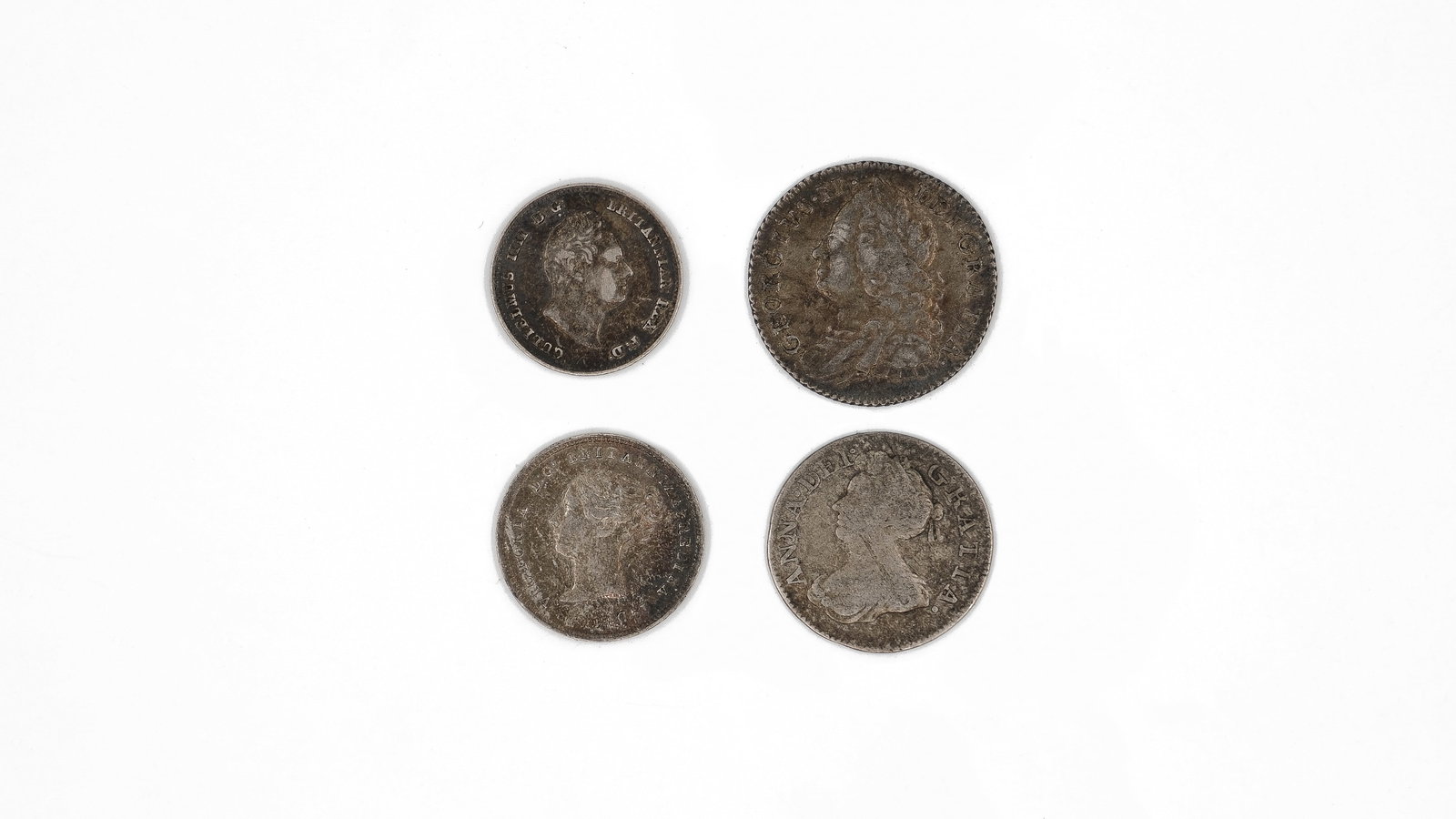 A lot of four British silver coins, 18th-19th century: A lot of four British silver coins, 18th-19th century. Comprising various issues with laureate and draped busts of British monarchs on the obverse, reverses including seated Britannia and crowned deno