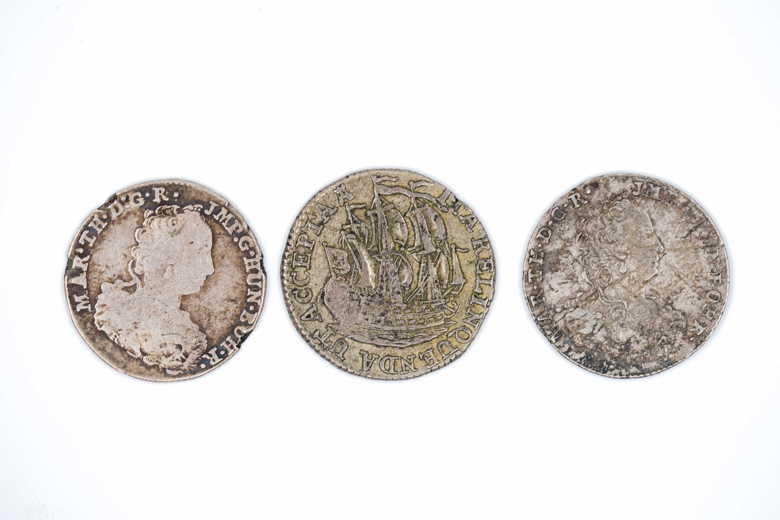 A lot of three European silver coins, 18th century: A lot of three European silver coins, 18th century. Comprising various types with portrait busts on the obverse and crowned armorial shields on the reverse, dated mid to late 18th century. Weight: 3,8