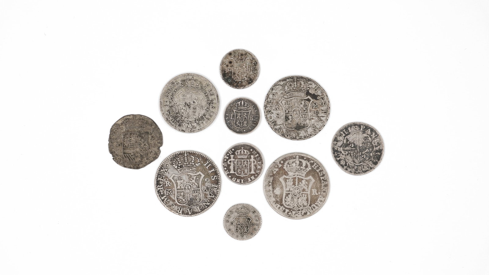 A lot of 10 European silver coins: A lot of 10 European silver coins. Comprising various antique issues including Spanish and related types, with portrait busts on the obverse and crowned armorial shields on the reverse. Total weight: 